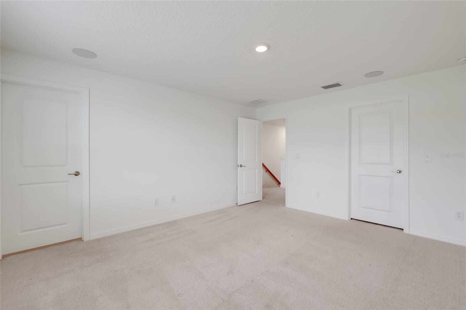 The master bedroom has its own master bathroom (shown with the door shut) and speakers in the ceiling as part of the full-house stereo system! - 15150 GINETTI ST, NOKOMIS