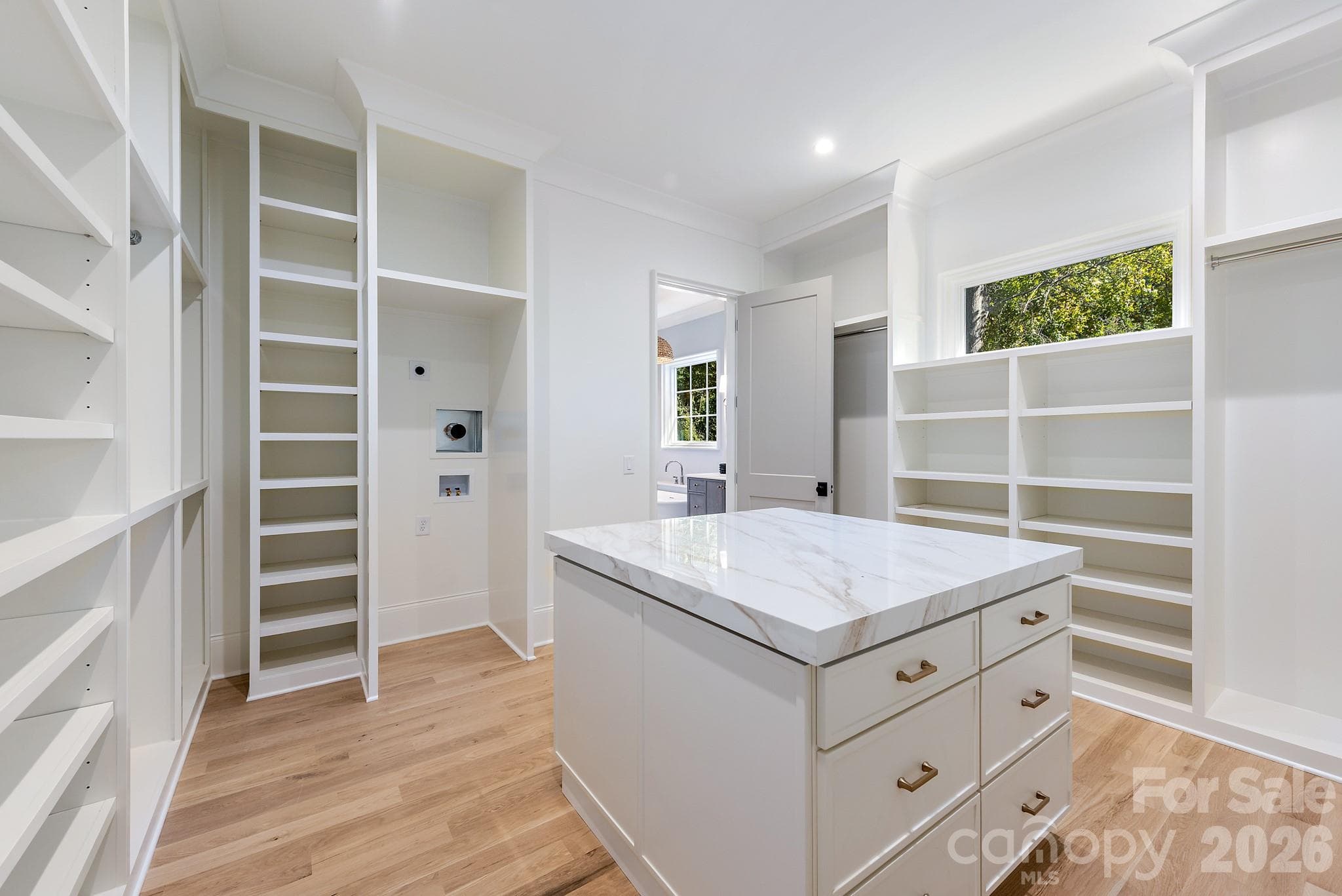Main level primary suite with walk in closet, washer/dryer hookup and island. - 133 Wonderwood Drive, Charlotte