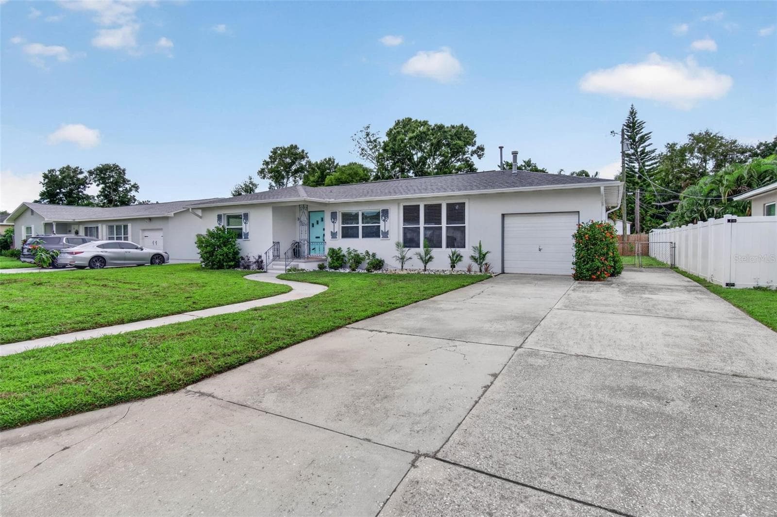 Notice there is plenty of room to park on extra wide parking pad leading to garage - 3312 MELTON ST N, ST PETERSBURG
