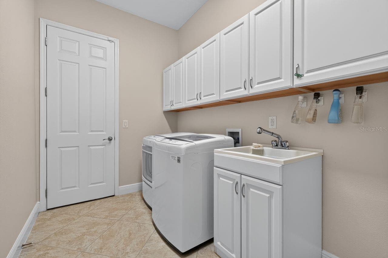 Laundry room with extra cabinets - 17115 4TH AVE E, BRADENTON