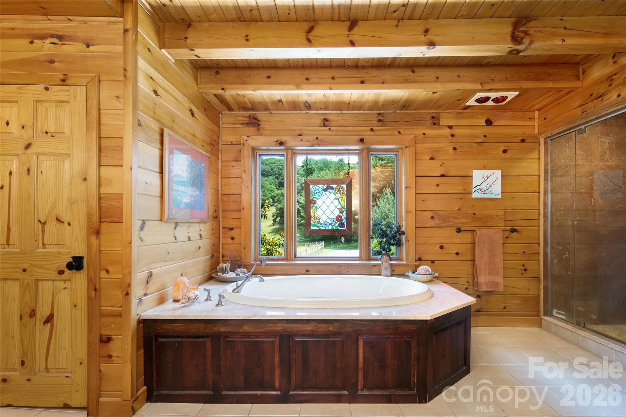 Primary bathroom on main level; garden tub with window view of greenery! - 316 Stevenson Cove Road, Waynesville