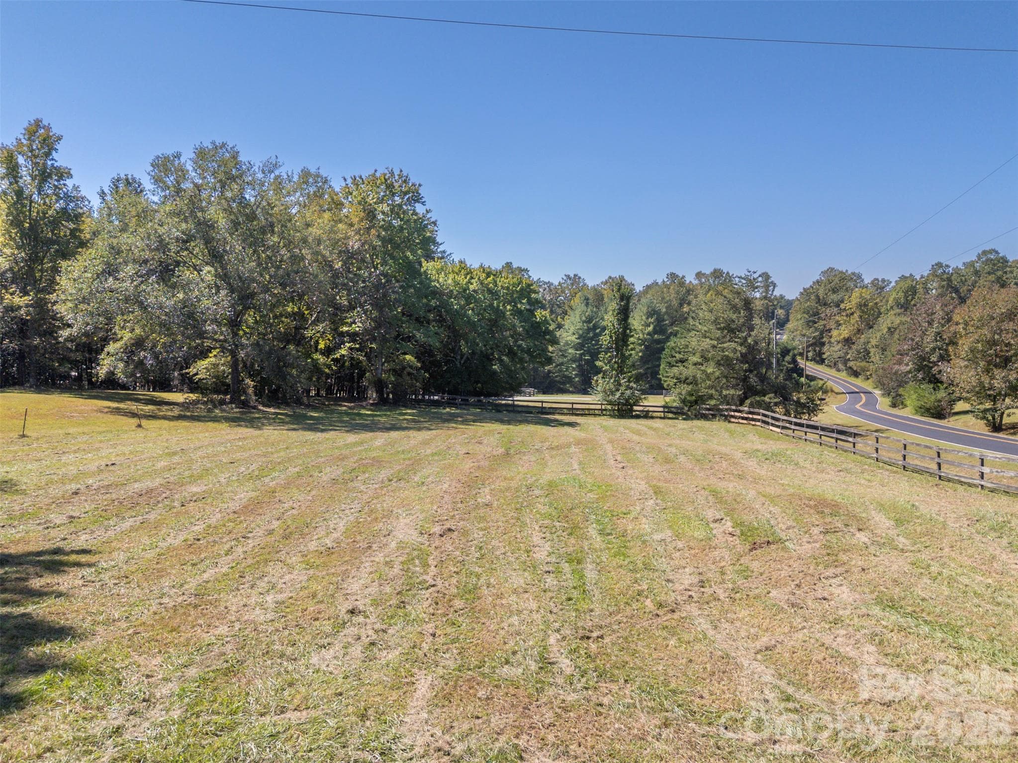 Pasture to right of driveway coming in.  This is a circular driveway behind the trees but has not been used in years and tree has grown over driveway. - 600 John Weaver Road, Columbus
