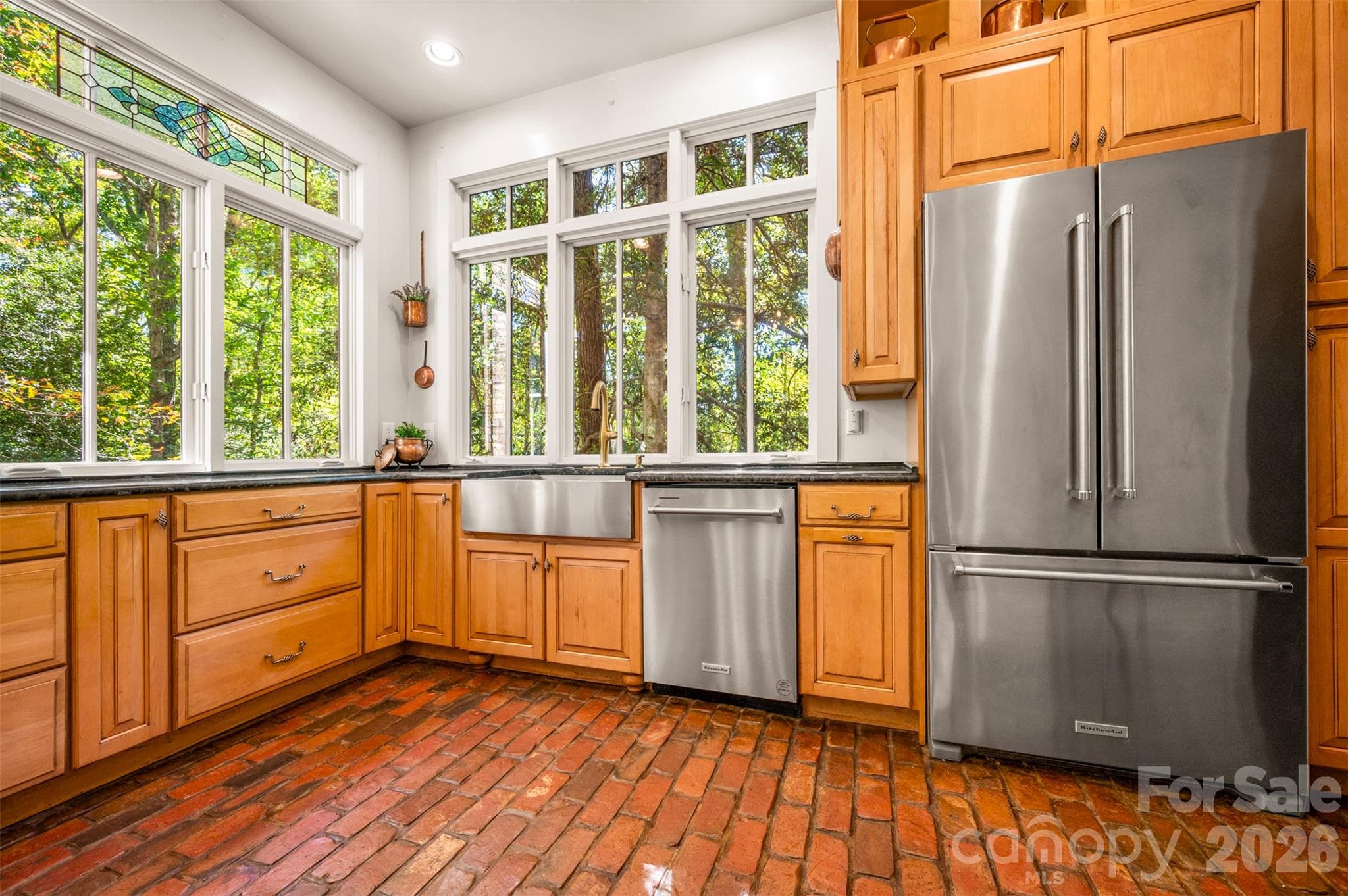 Beautiful wood cabinetry with farmhouse sink, granite counters, SS appliances and handmade oversized brick floors. - 600 John Weaver Road, Columbus