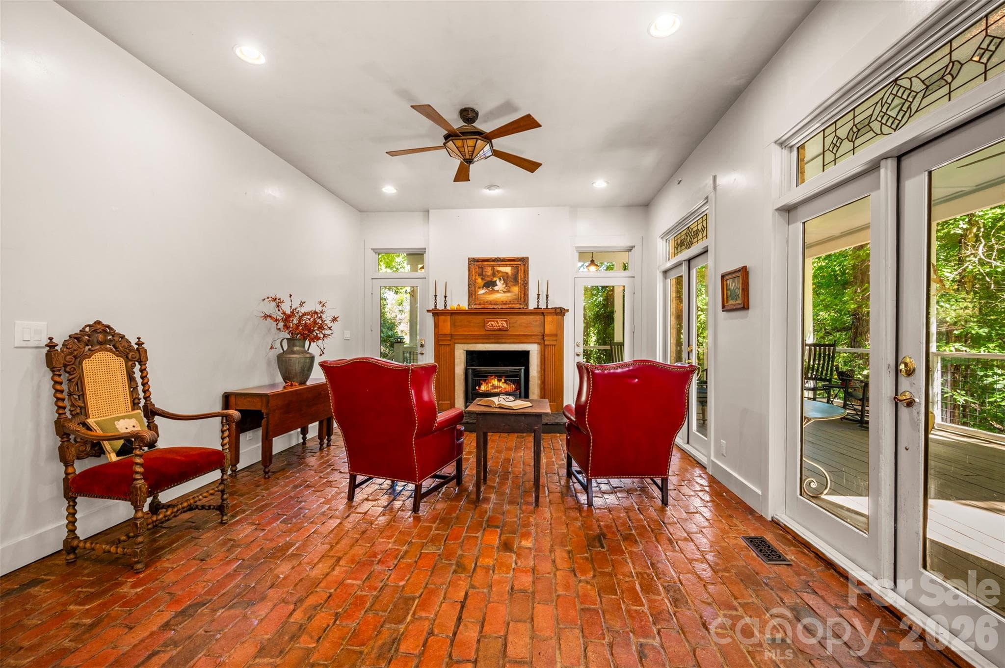 Sitting area beside kitchen with gas log fireplace surrounded by reclaimed antique wood mantel. - 600 John Weaver Road, Columbus
