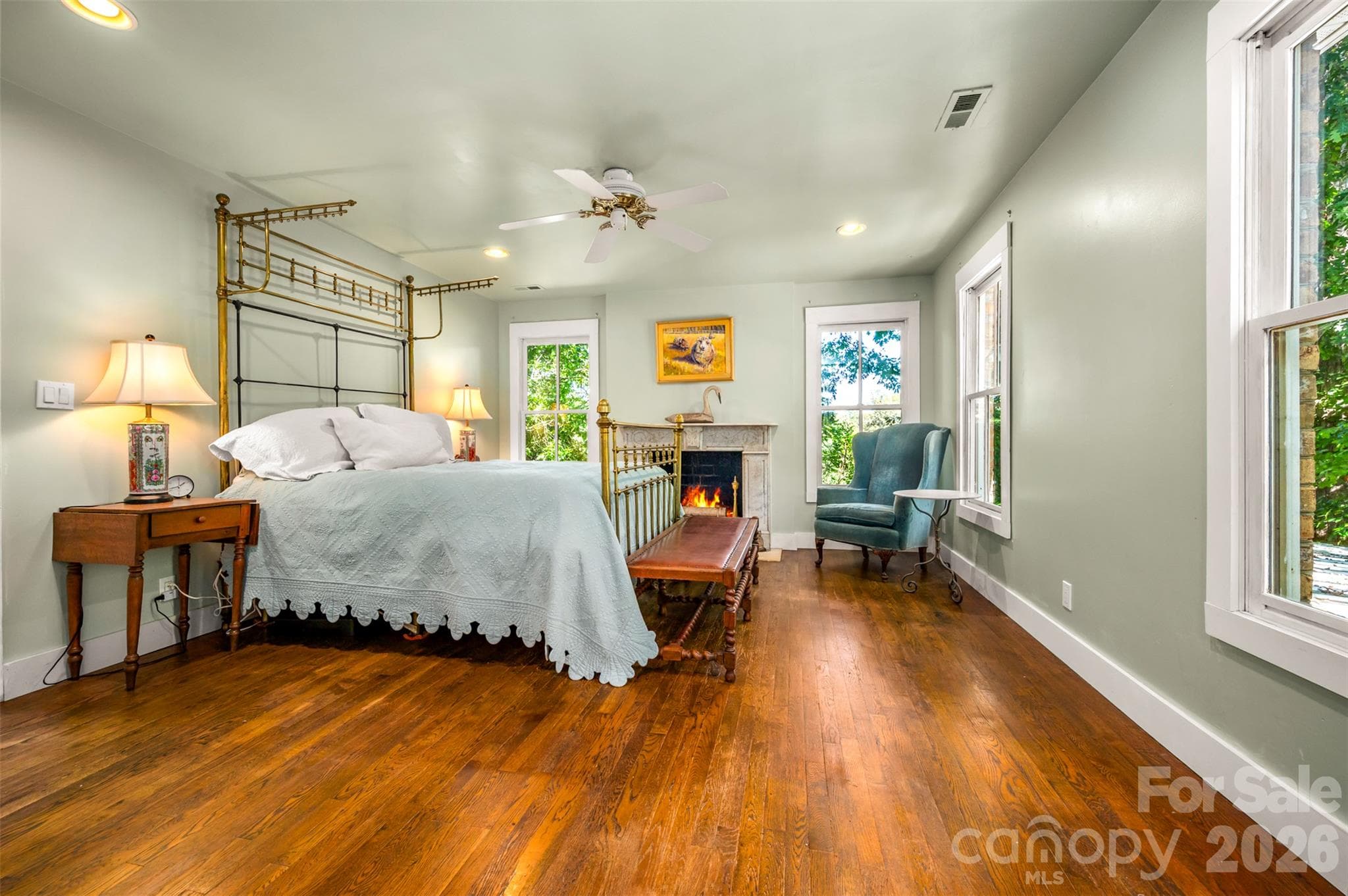 Primary bedroom with fireplace also surrounded by reclaimed antique fireplace mantel. - 600 John Weaver Road, Columbus