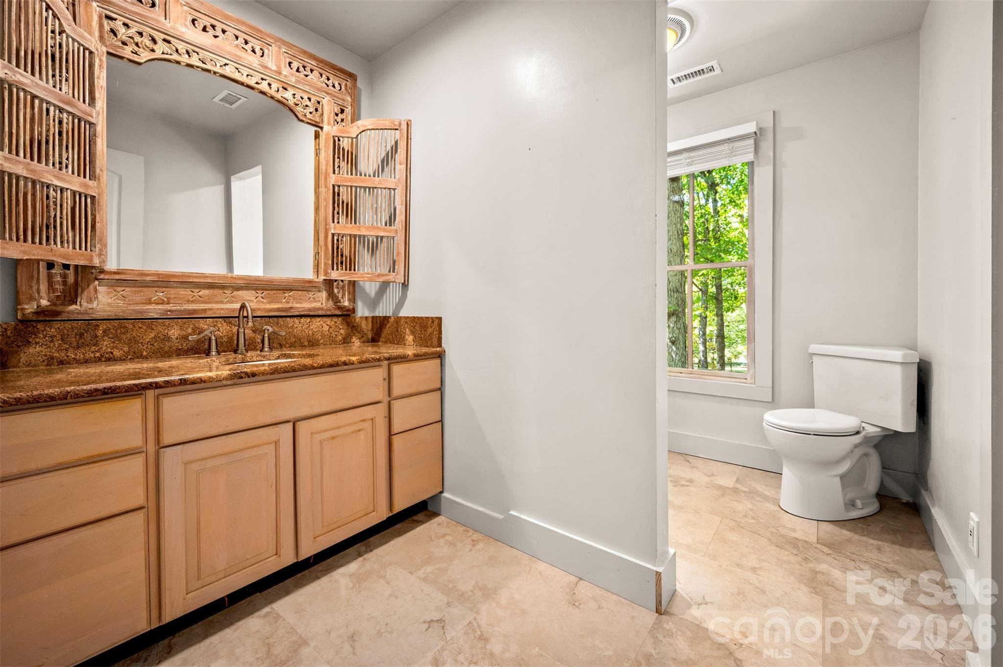 New hall bath with unique bathroom mirror and granite counters. - 600 John Weaver Road, Columbus