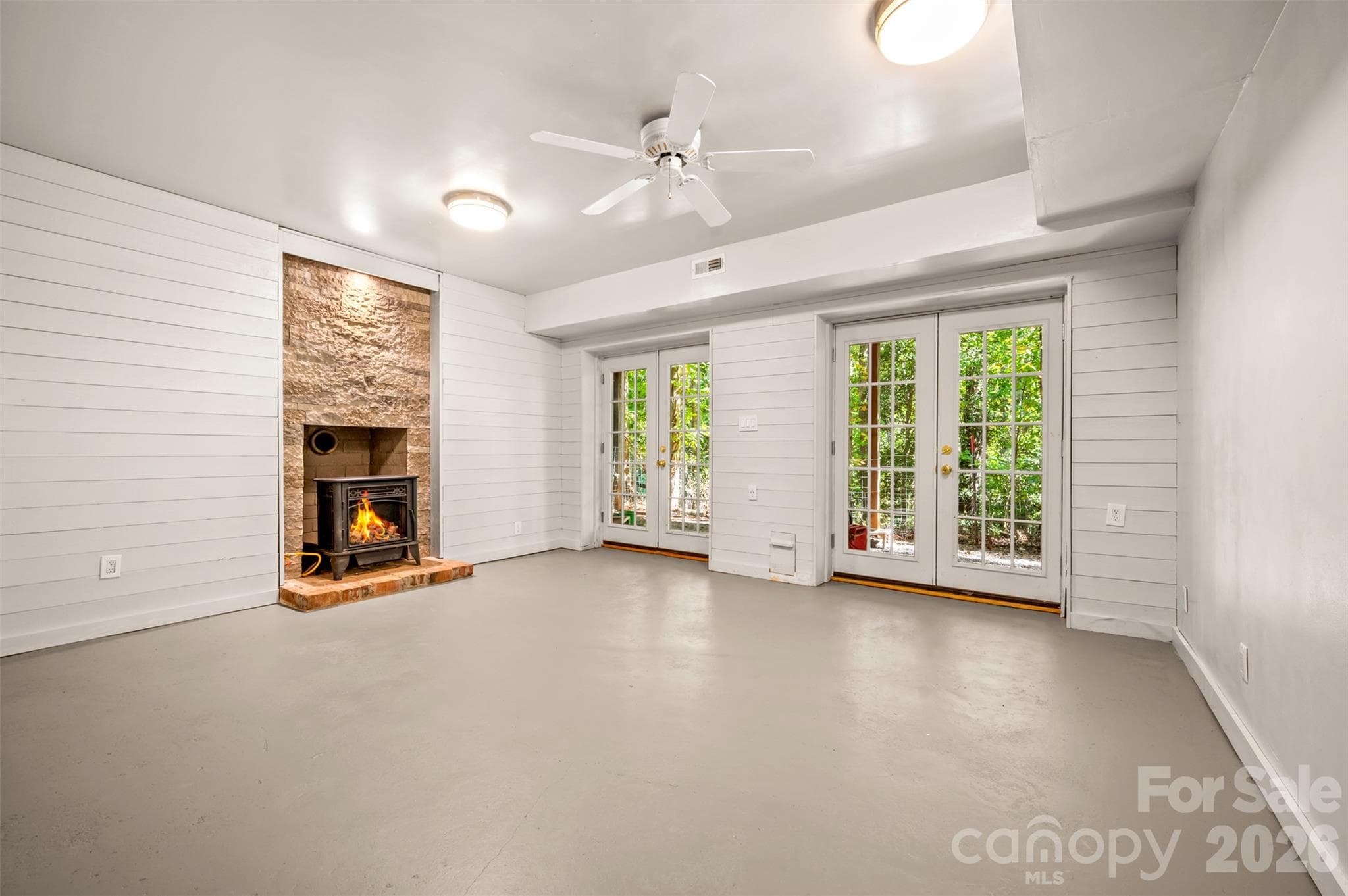 Basement Family room with unvented gas wood stove (vented for wood burning stove)  PAINTED CONCRETE FLOORS - 600 John Weaver Road, Columbus