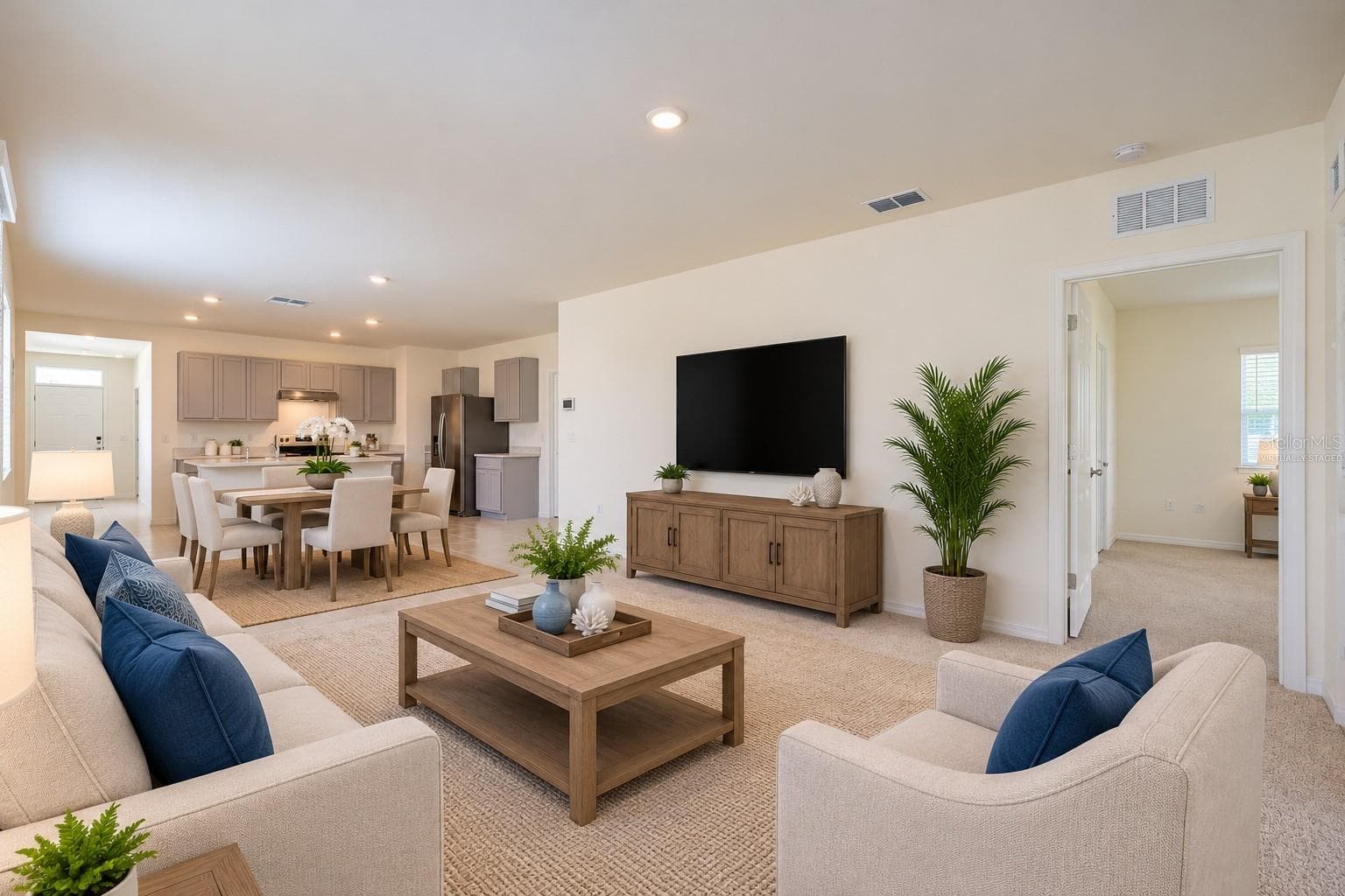 Virtually Staged, The spacious living room offers high ceilings and a glass sliding door leading to the Florida room - 2415 BRASSIE CT, WINTER HAVEN