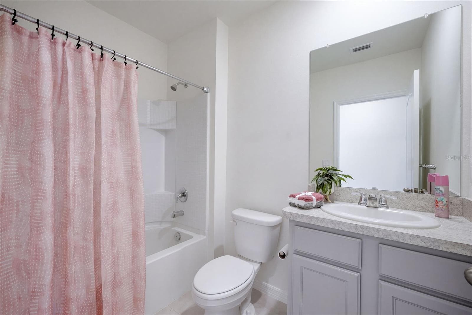 Guest Bathroom features a comfort height vanity with tub/shower unit - 2415 BRASSIE CT, WINTER HAVEN