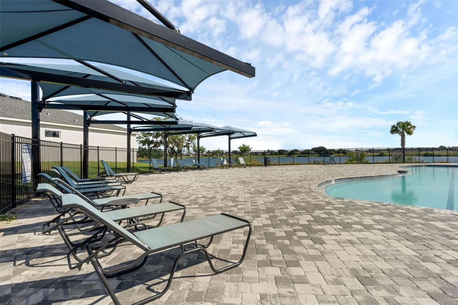 Pavers are featured in the community pool lounging area - 2415 BRASSIE CT, WINTER HAVEN