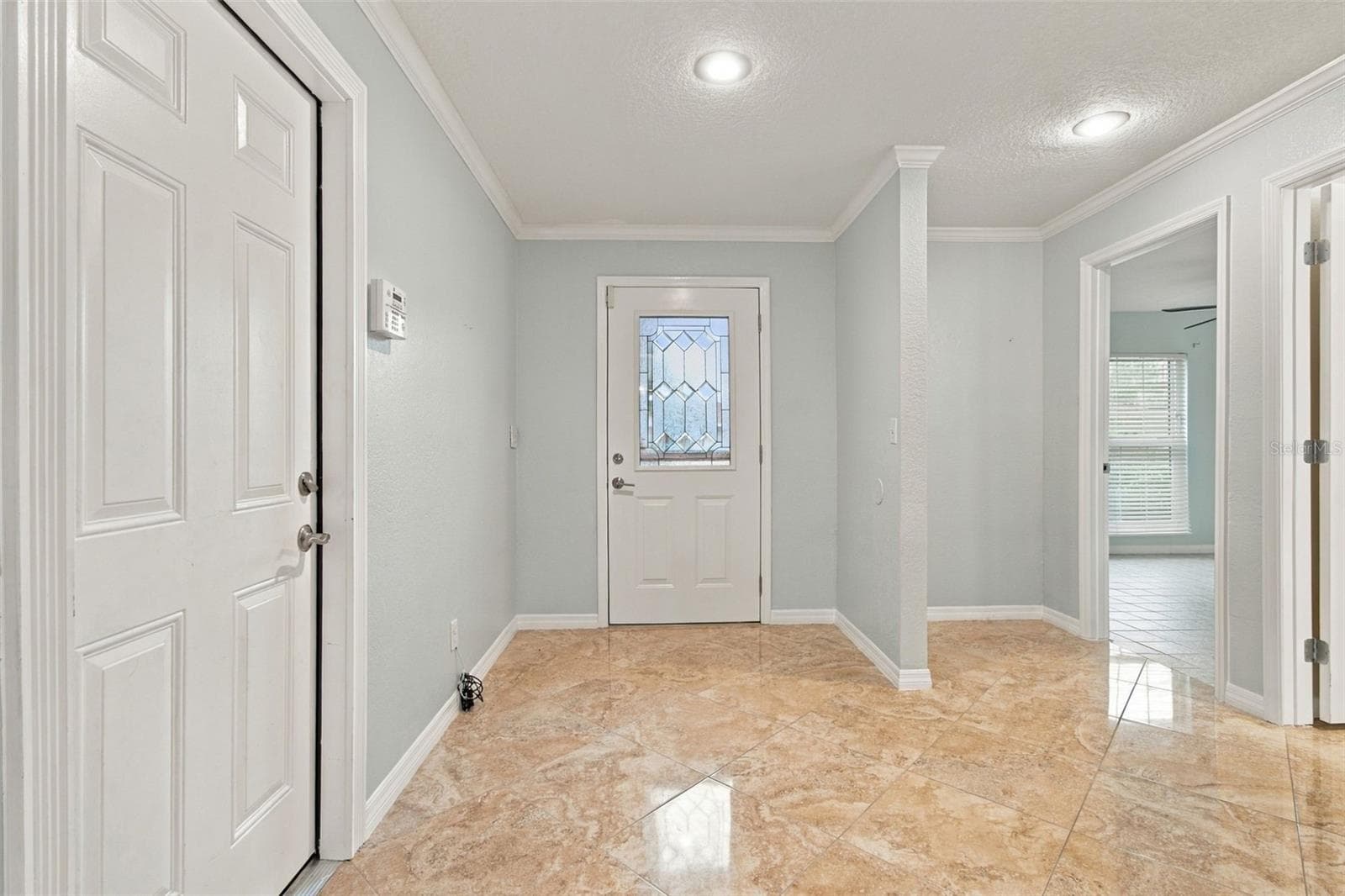 The foyer is spacious for entry furniture. The wall keeps the front bedroom private from the entry. - 2254 HERON CIR, CLEARWATER