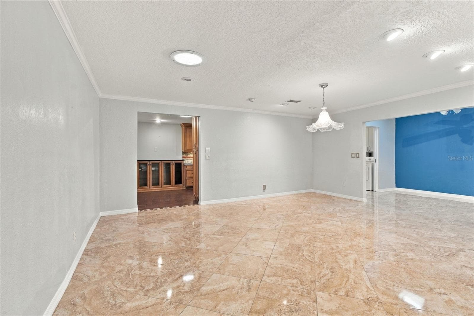 Wow! This dining room is huge and opens to the Sunroom with two skylights on the right and the kitchen on the left. - 2254 HERON CIR, CLEARWATER