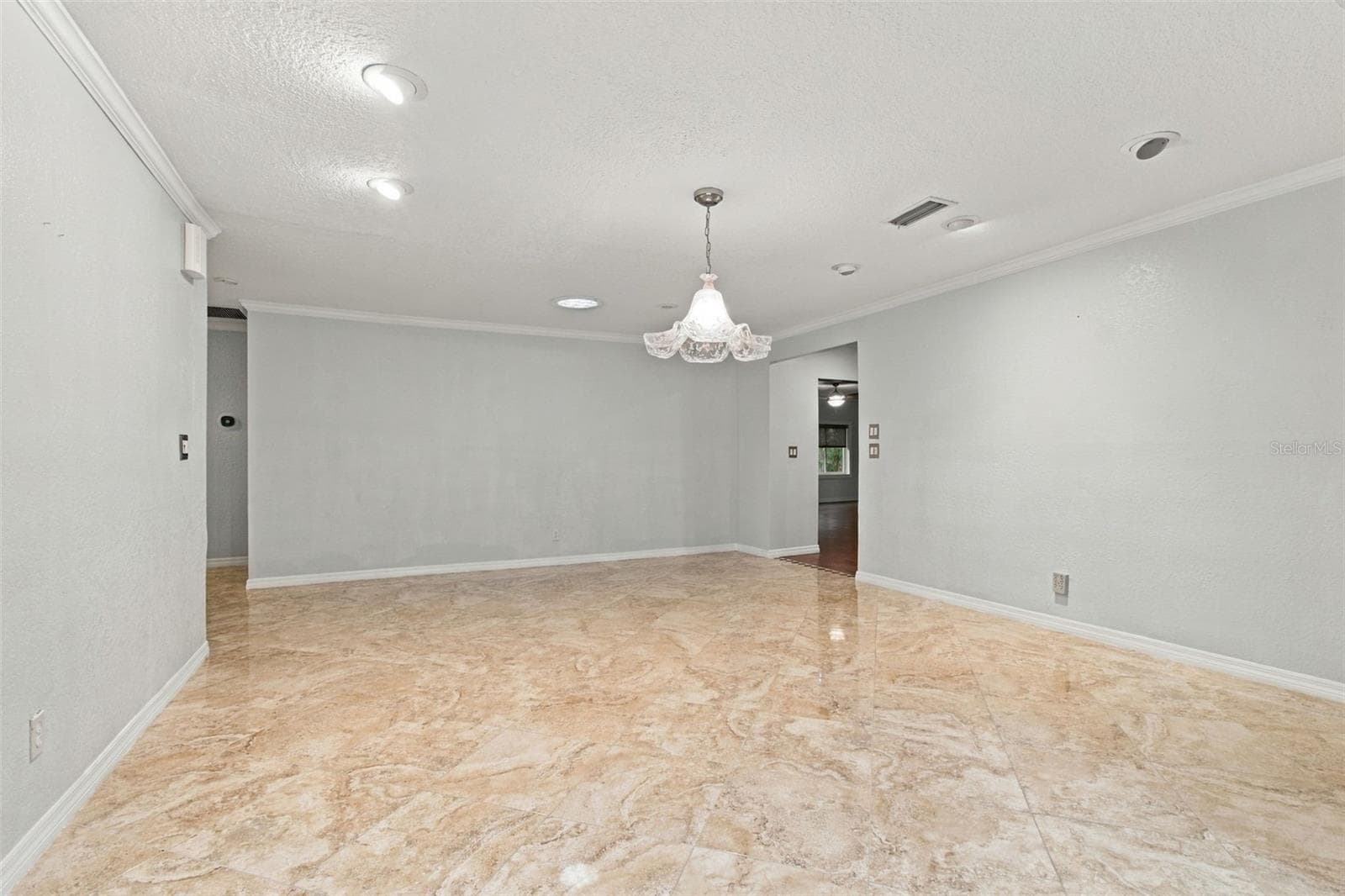 This view of the dining room is looking towards the kitchen entry to the right. Lots of wall space here for stand-alone cabinets and both standing and wall art. - 2254 HERON CIR, CLEARWATER