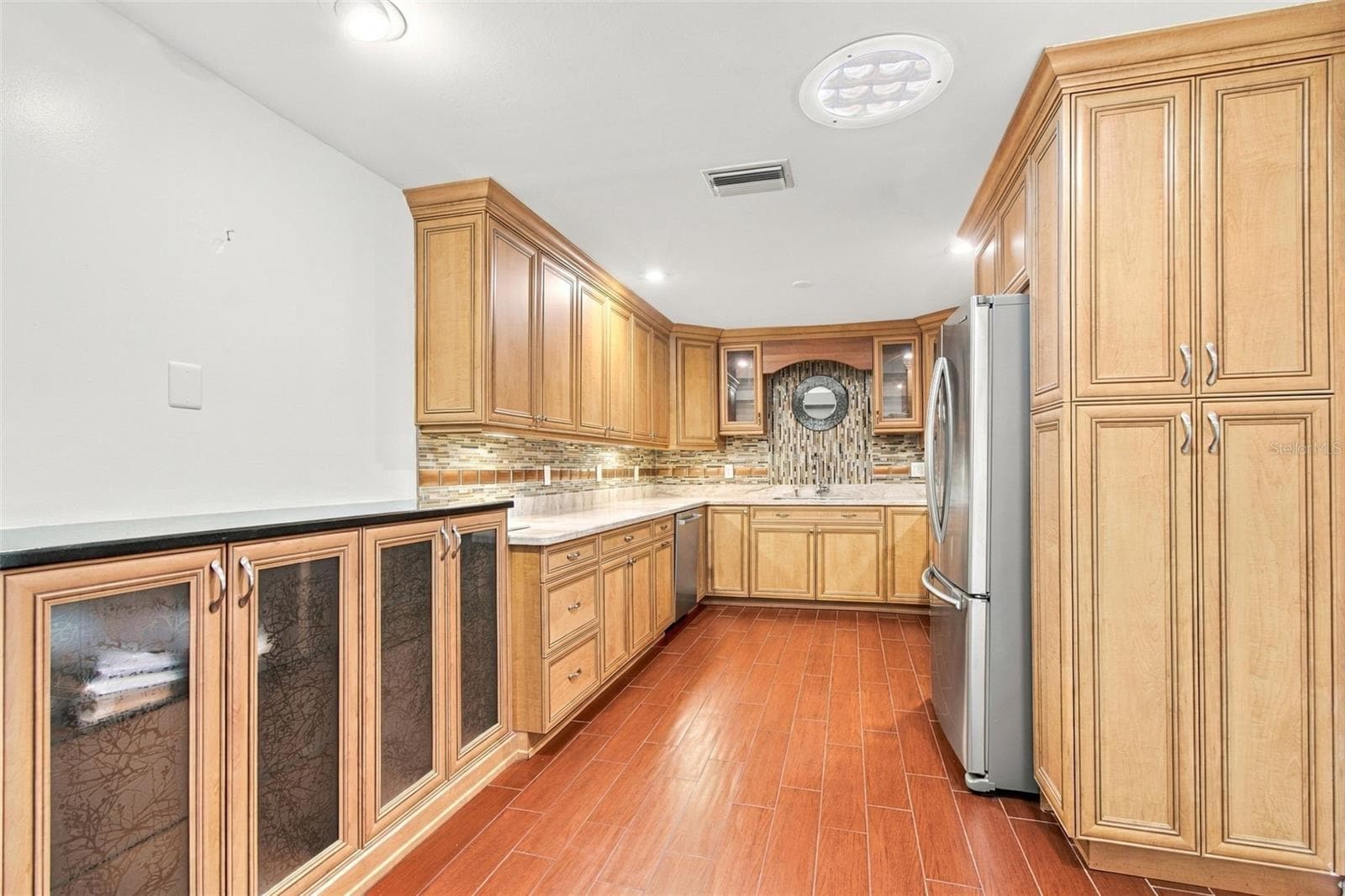 This custom kitchen has plenty of counter, cupboard, and cabinet space. - 2254 HERON CIR, CLEARWATER