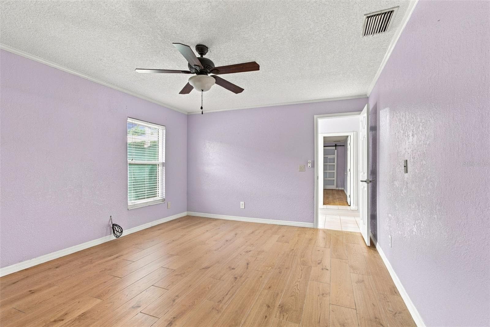The primary bedroom is off the living area and features a private spa-like bathroom and a huge walk-in closet. - 2254 HERON CIR, CLEARWATER