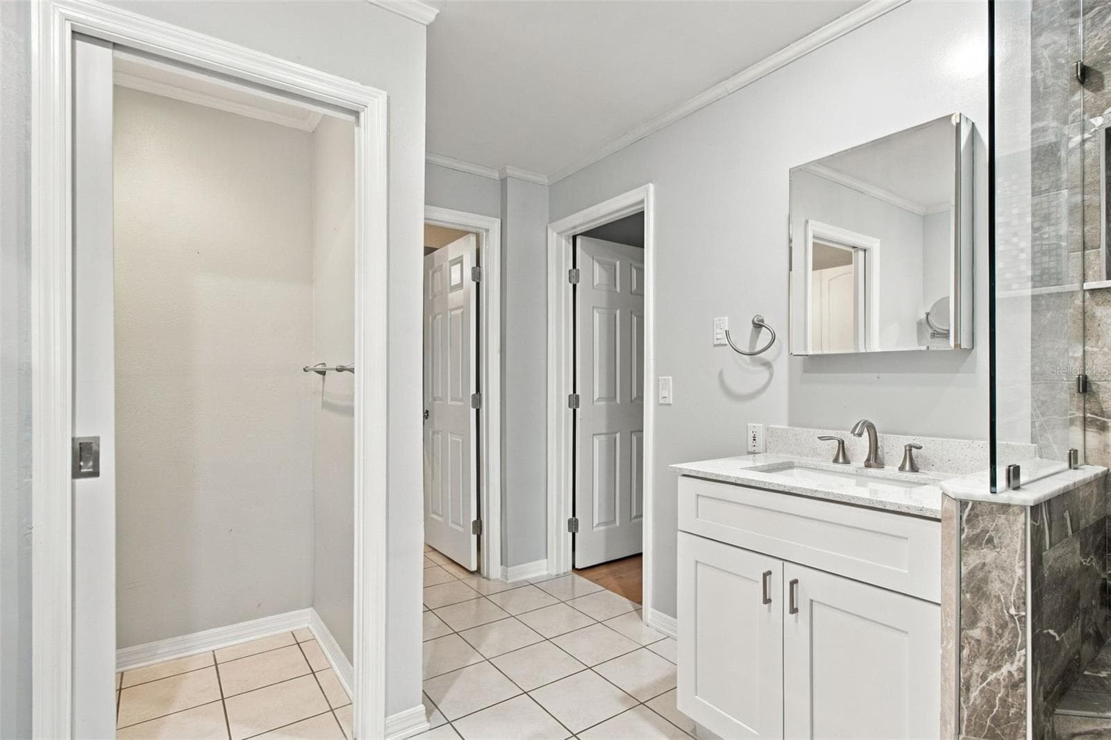 Kind of an odd shot but it shows the water closet on the left. Door in the middle is to the walk-in closet and door on right, to the primary bedroom. Not as odd as it looks. - 2254 HERON CIR, CLEARWATER
