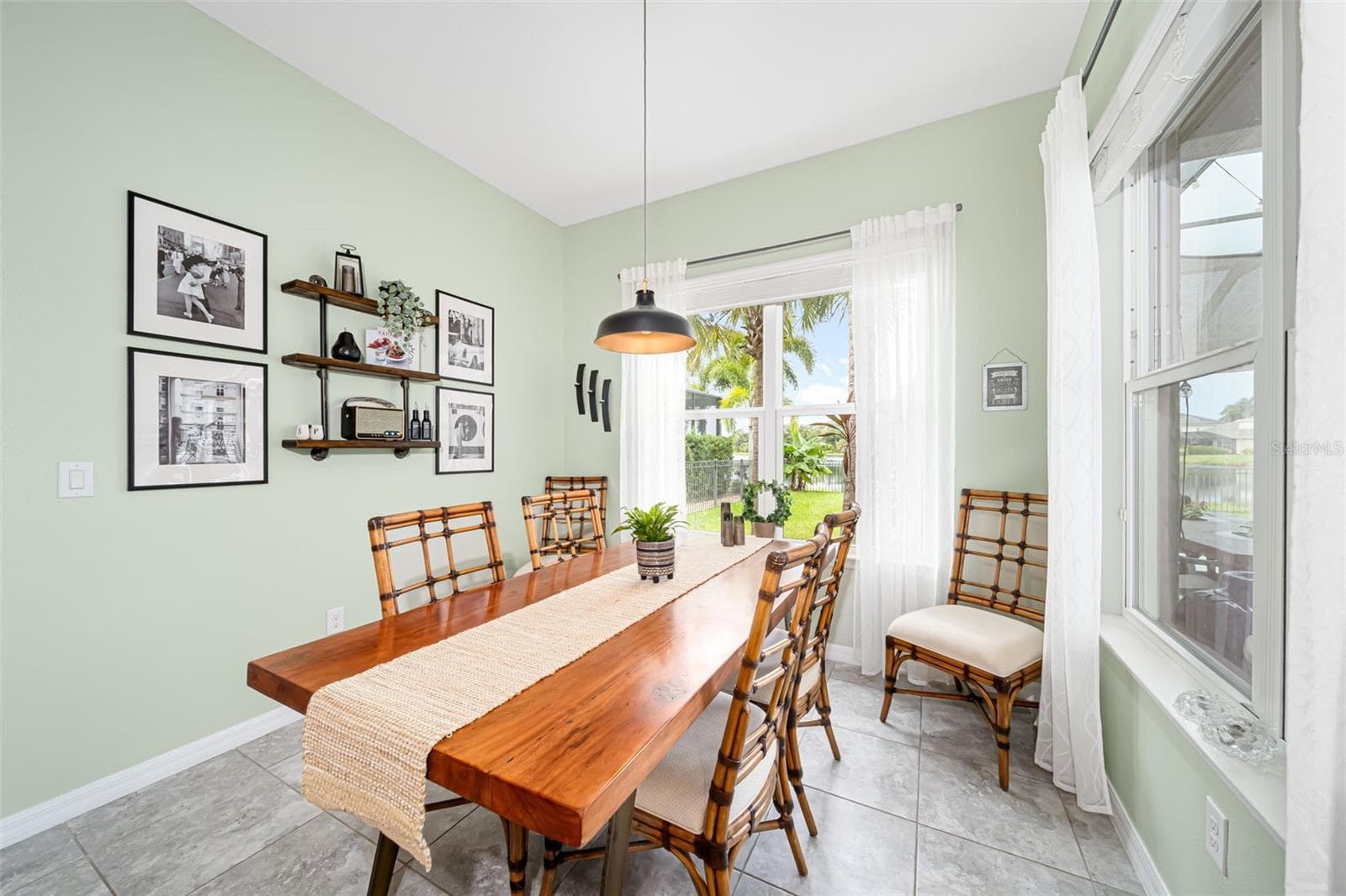 Gather around the table and enjoy serene lake views with every meal. - 6195 ANISE DR, SARASOTA