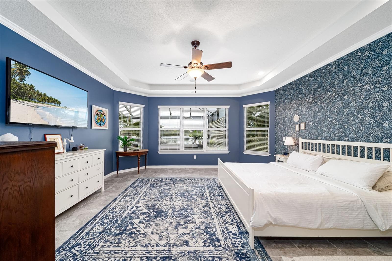 Primary bedroom with beautiful views and elegant designer wallpaper. - 6195 ANISE DR, SARASOTA