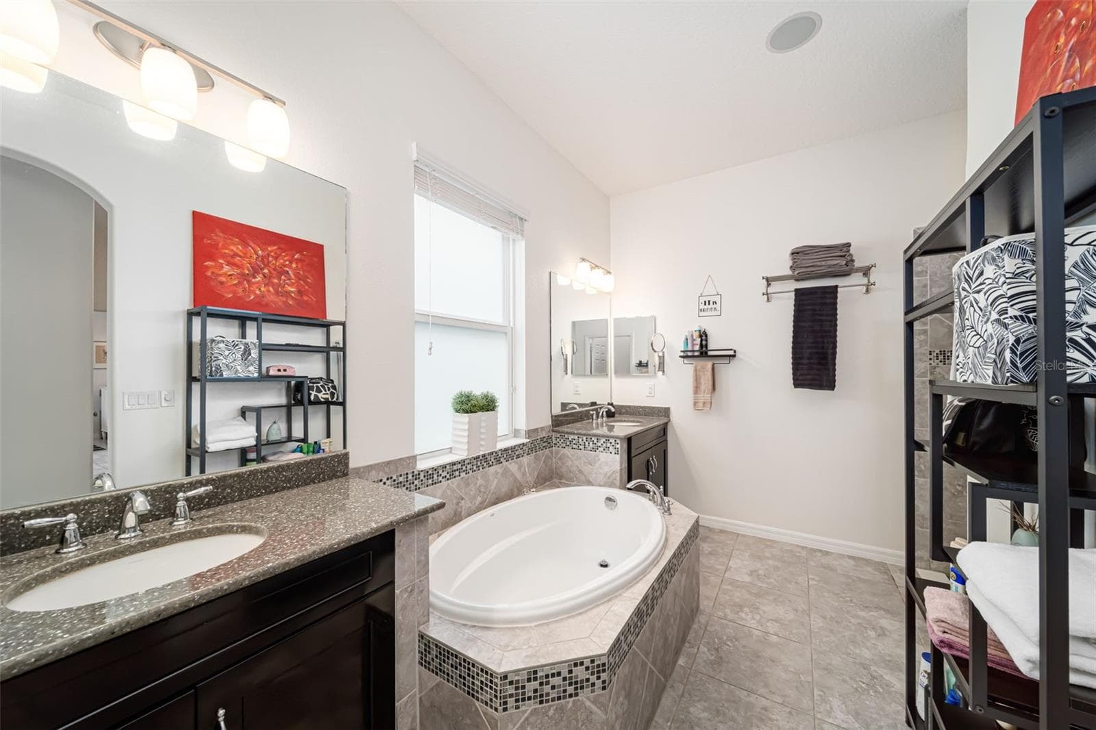 Spacious primary bath with a walk-in shower, dual vanities, and a relaxing soaking tub. - 6195 ANISE DR, SARASOTA