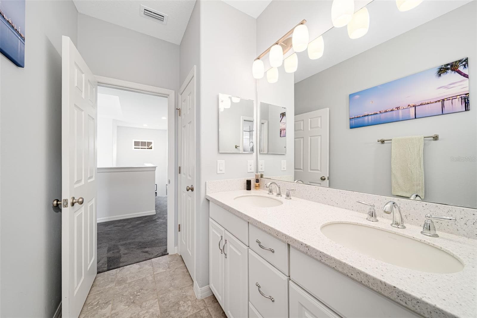 Bathroom with a spacious dual-sink vanity and tub-and-shower combination. - 6195 ANISE DR, SARASOTA