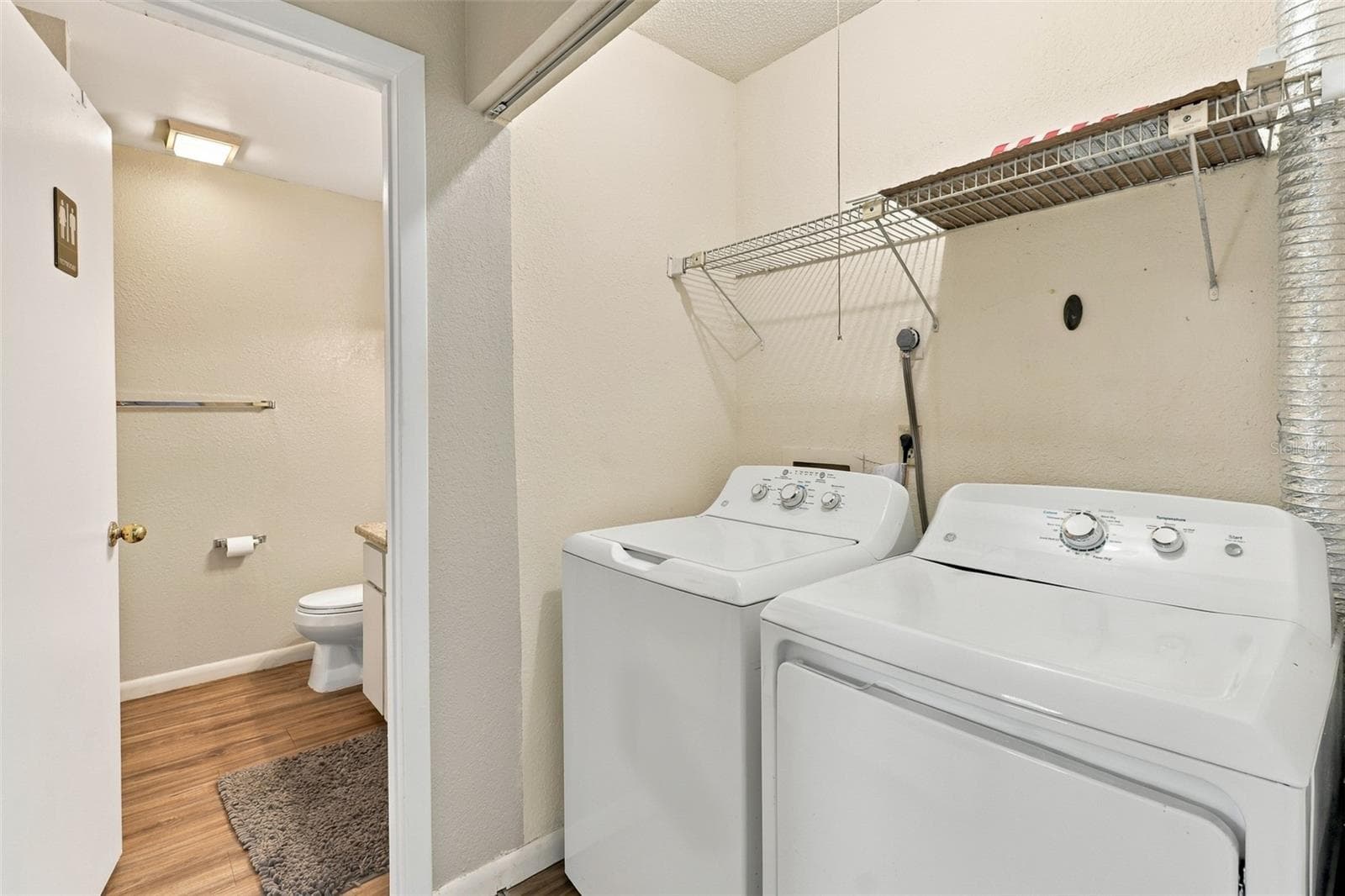 hallway to guest bath with washer and dryer included - 480 LANDING BLVD, INVERNESS