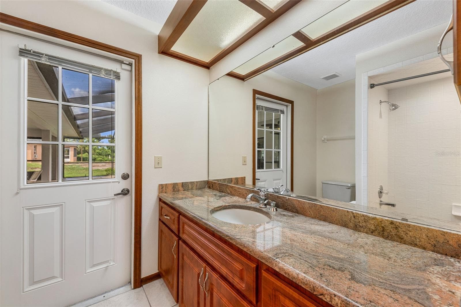 Second Bathroom with door leading out to screened in lanai/pool area - 930 ALBRITTON WAY, LAKE WALES
