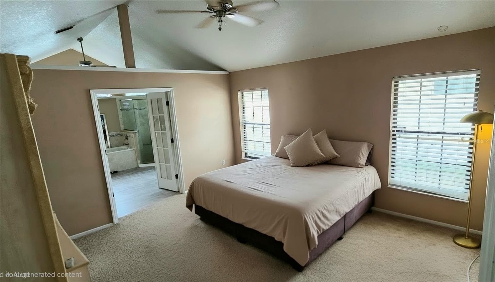 Primary bedroom with french doors to ensuite bath. - 678 FAIRCHILD AVE, DELTONA