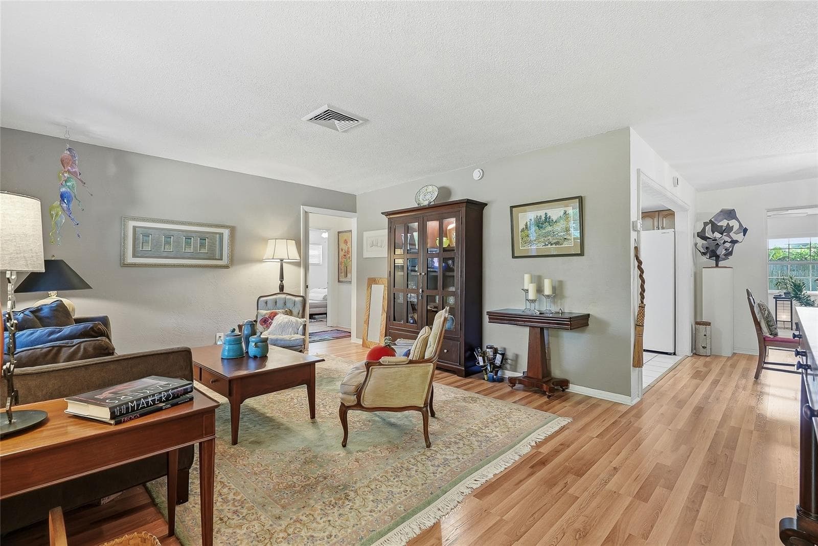 Room to gather and unwind. The spacious living room offers flexible furniture arrangements and easy access to the kitchen, dining area and guest bedrooms, separated by a working pocket door. - 1890 62ND AVE S, ST PETERSBURG