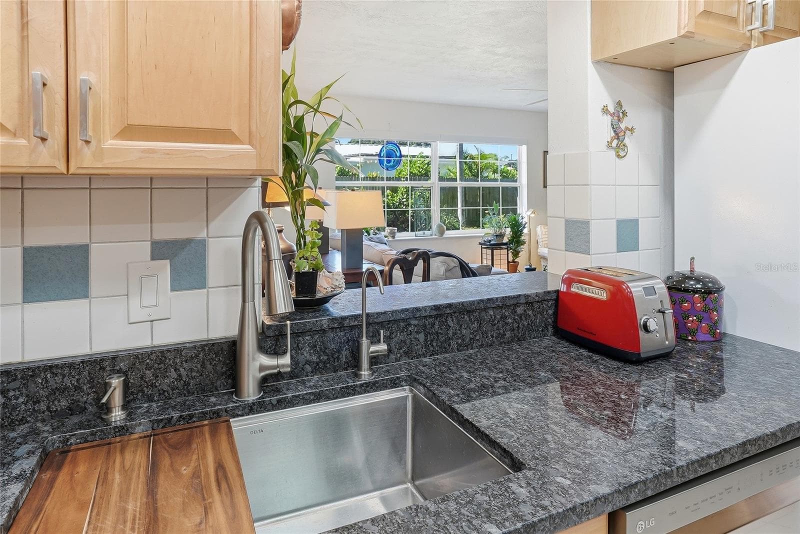 Stay part of the conversation while preparing meals, with an open pass-through overlooking the bright family room and its leafy backyard views. - 1890 62ND AVE S, ST PETERSBURG