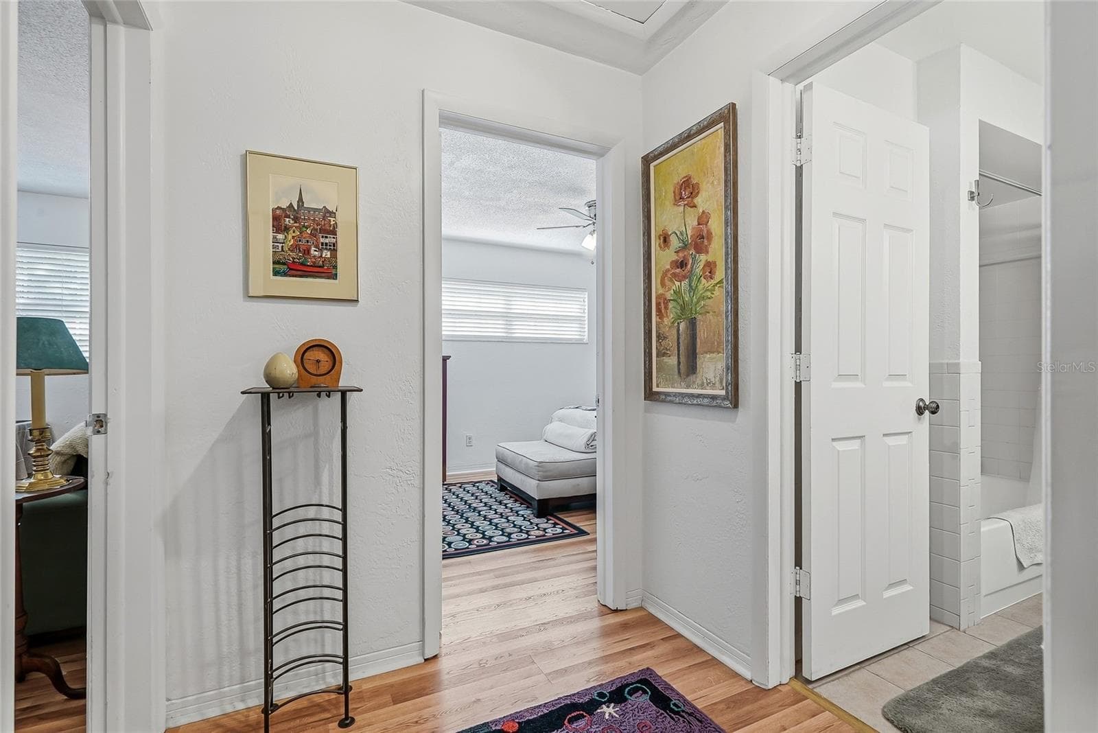 Two additional bedrooms and a shared bath are grouped together off their own hallway, creating a comfortable setup for guests or a bedroom and home office. - 1890 62ND AVE S, ST PETERSBURG