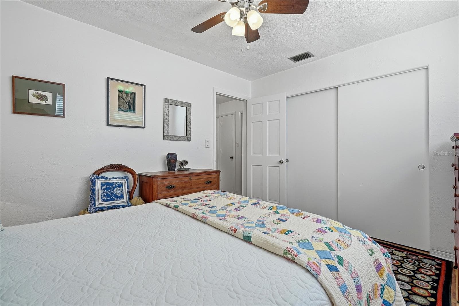 A wide closet with sliding doors provides convenient storage while preserving floor space for your bedroom furnishings. - 1890 62ND AVE S, ST PETERSBURG