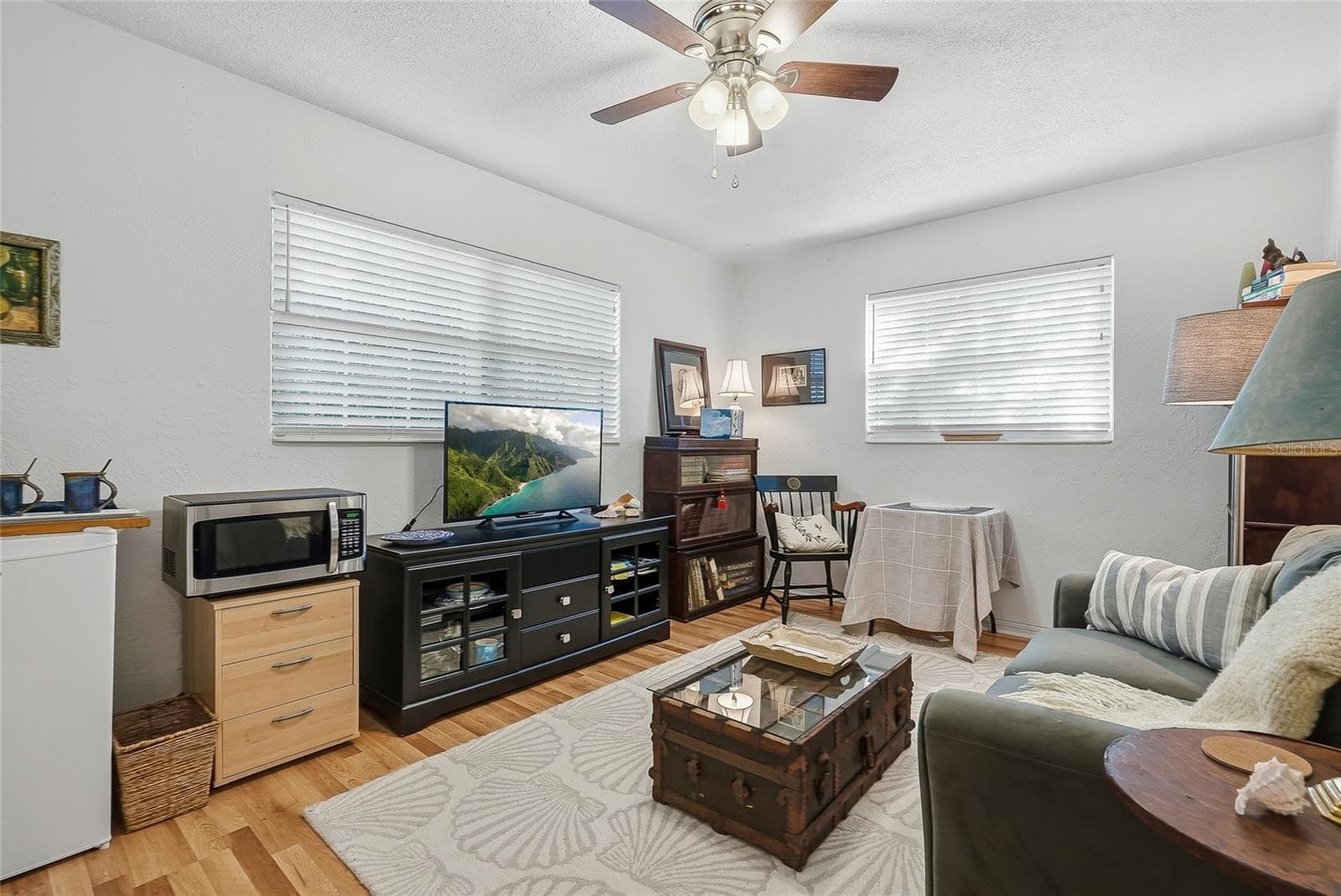 Windows on two walls brighten this versatile bedroom, currently arranged as a relaxed sitting room with space to read, work, or unwind. - 1890 62ND AVE S, ST PETERSBURG