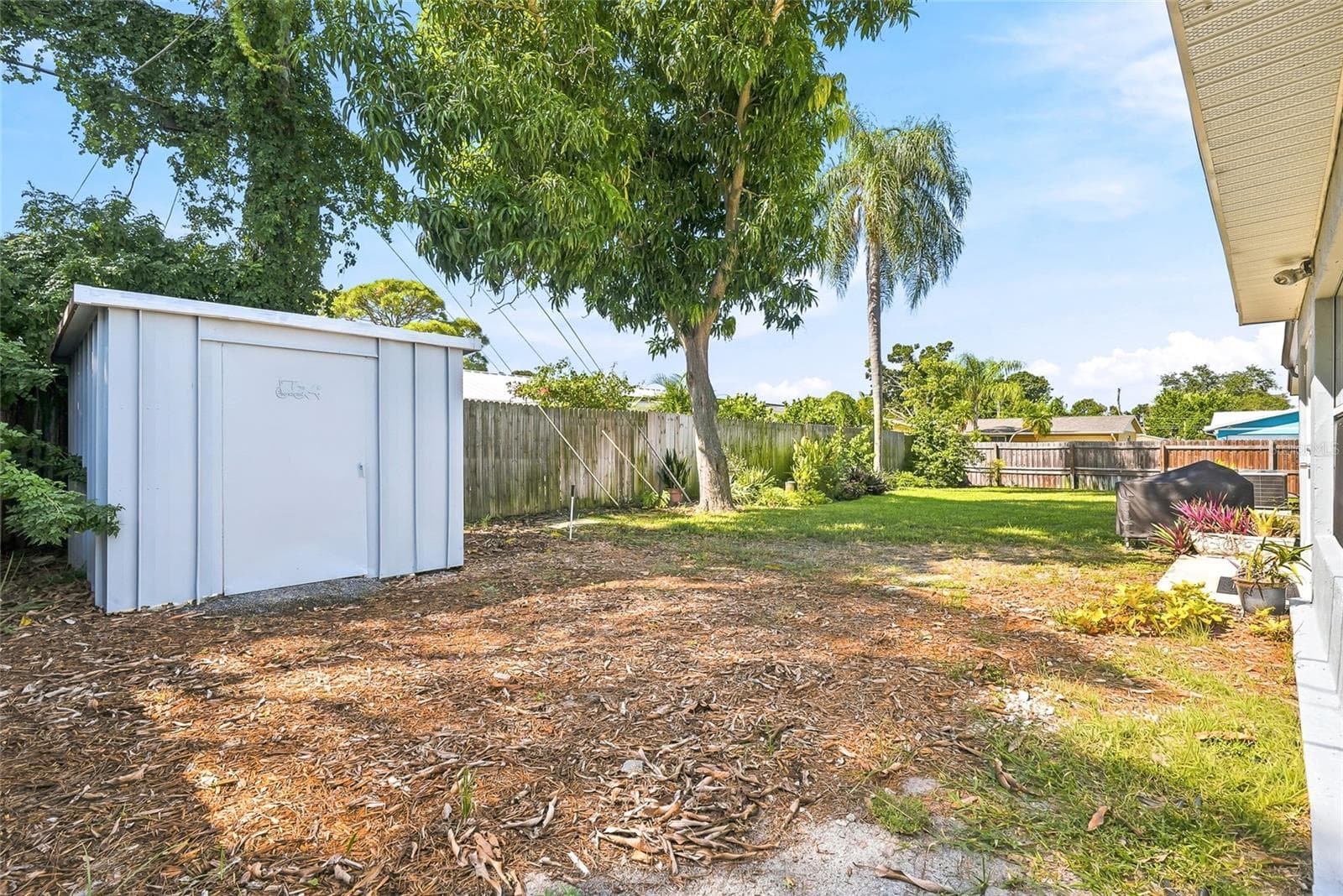 A handy backyard shed provides space for gardening tools and outdoor essentials, leaving more room to enjoy your surroundings. - 1890 62ND AVE S, ST PETERSBURG