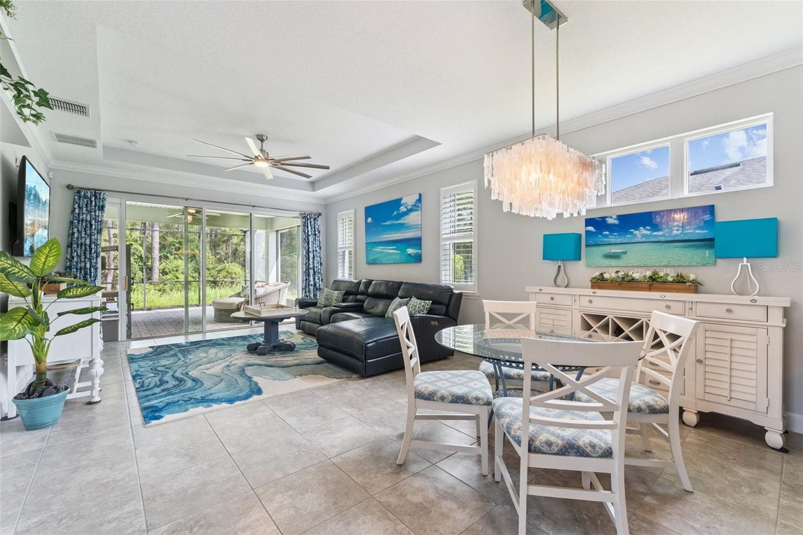 View of the Dining & Great Room areas w/ crown molding, tray ceiling & a ceiling fan - 1305 HAYTON AVE., DELAND