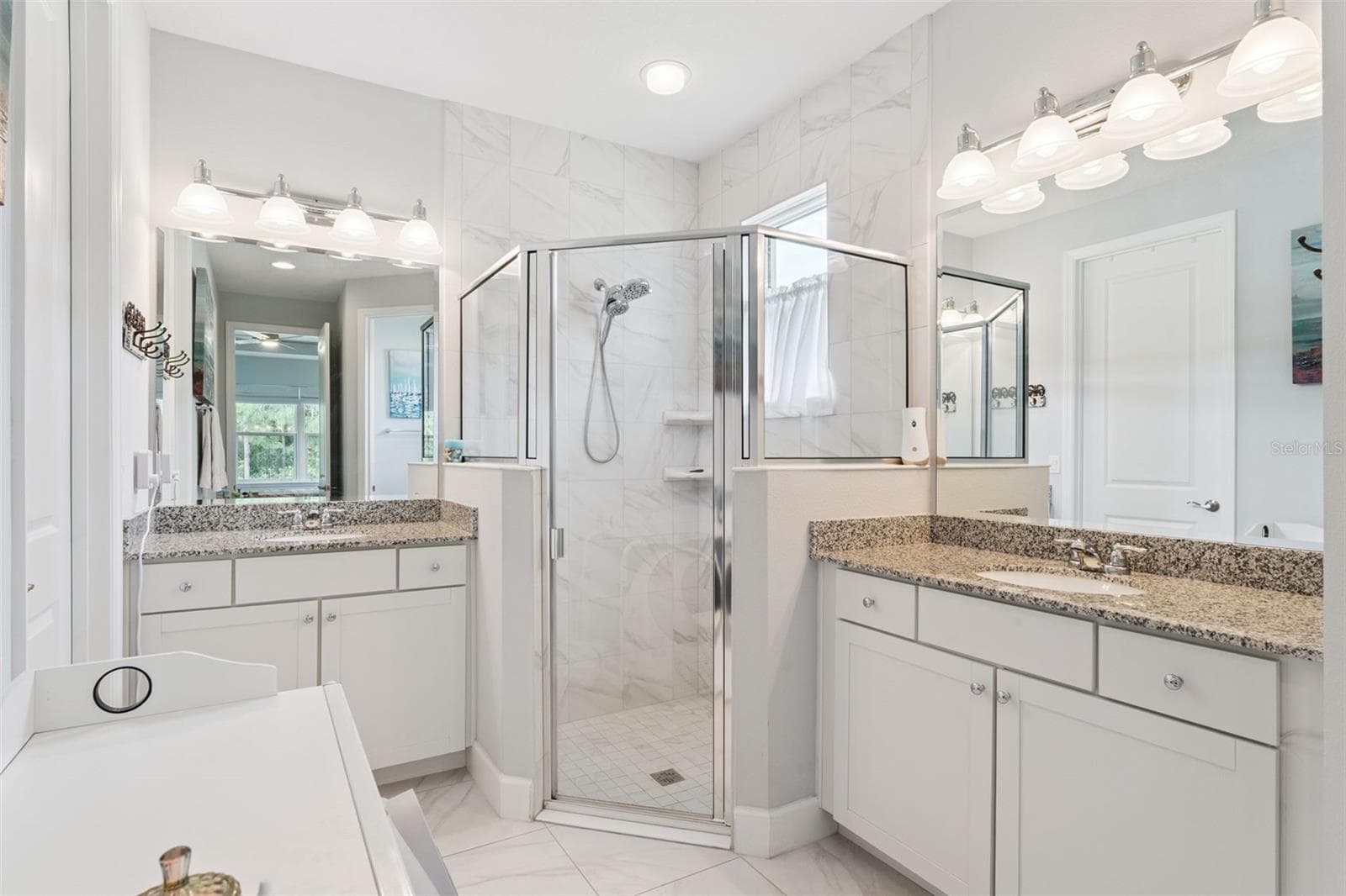 8' x 15' Primary Bathroom w/ separate granite countertop vanities, glass enclosed walk-in shower & bench seat - 1305 HAYTON AVE., DELAND