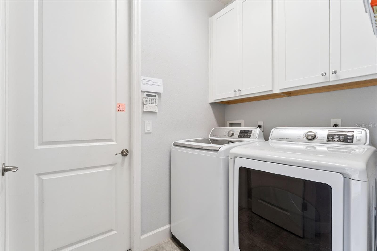 7' x 5'6" Utility Room w/ washer, natural gas dryer & storage cabinets - 1305 HAYTON AVE., DELAND