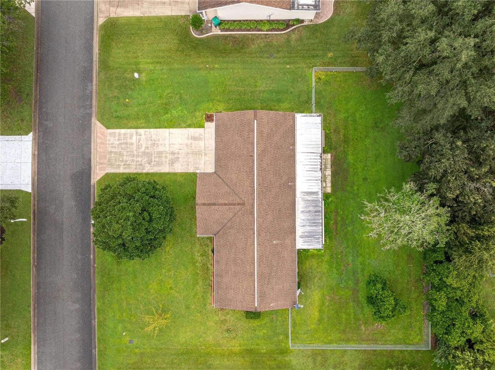 AERIAL OF THIS HOUSE SHOWING THE ROOF AND THE FENCED IN YARD - 10434 SE 178TH PL, SUMMERFIELD