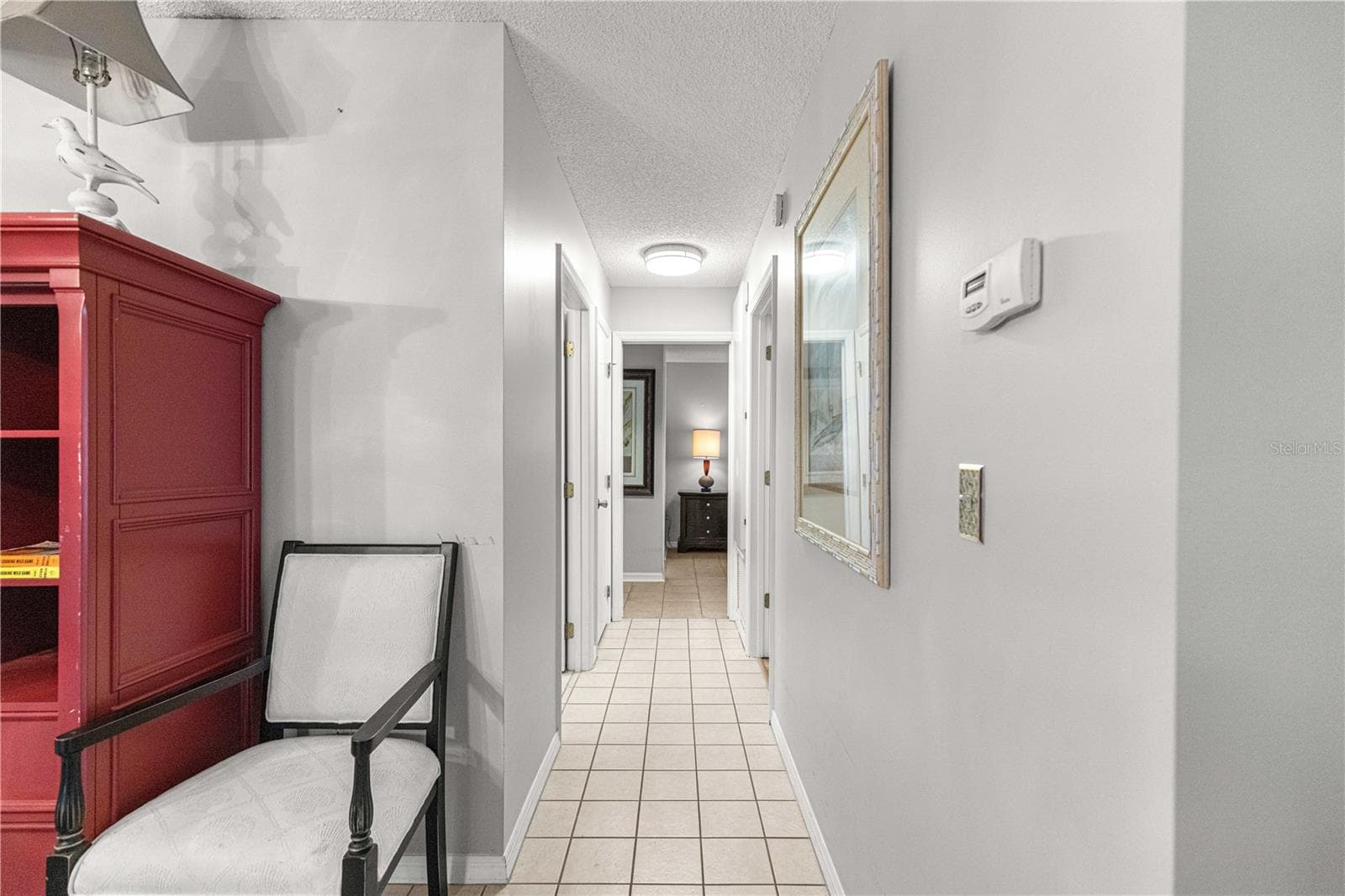 TILED HALLWAY TO BEDROOMS FROM DINING AREA - 10434 SE 178TH PL, SUMMERFIELD