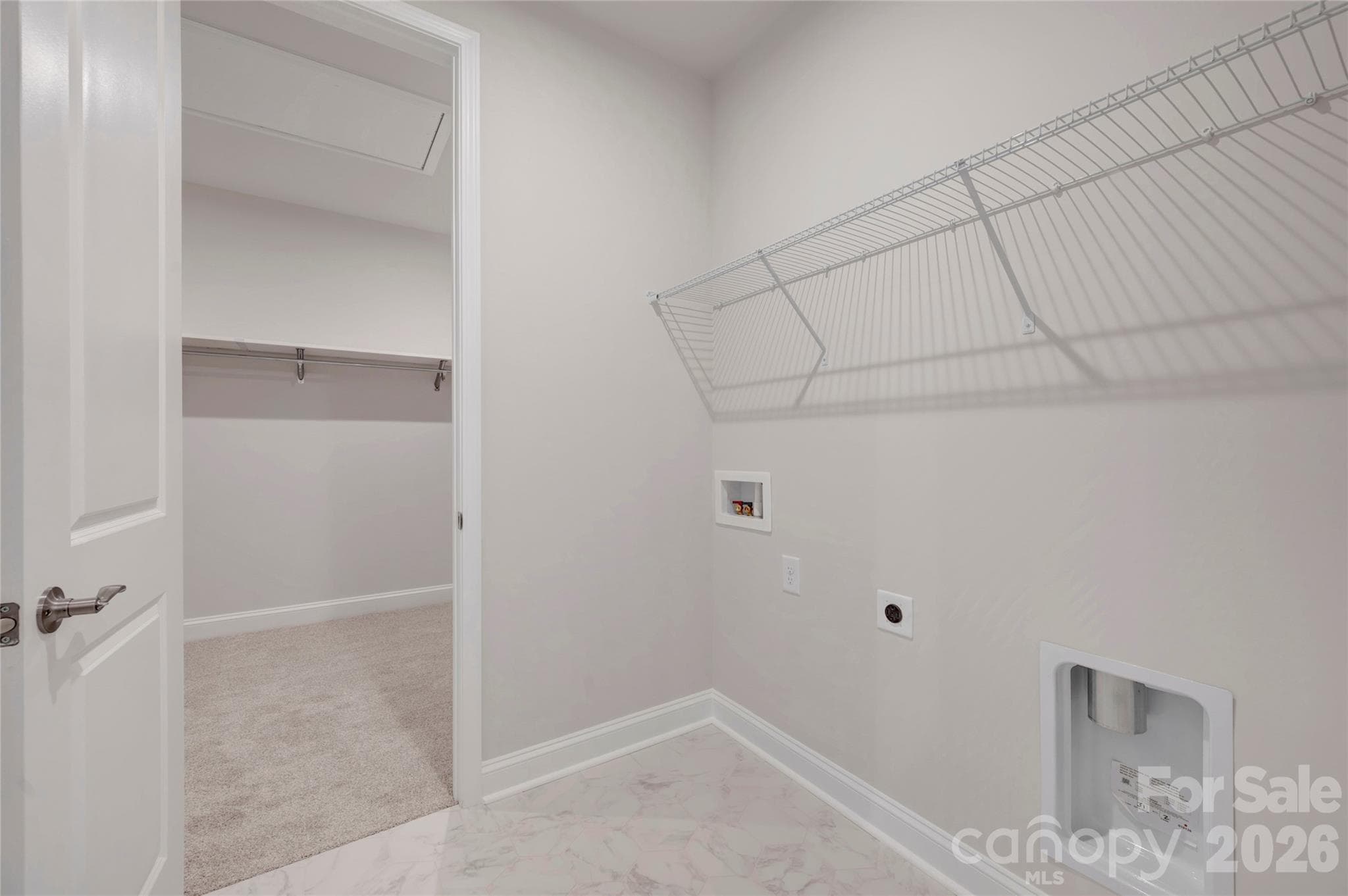 Laundry room with connection door into the primary walk-in closet - Fort Mill