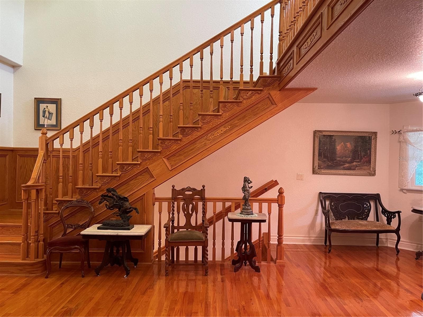 Admiring solid wood staircase and wood accents. - 5422 CYRIL DR, DADE CITY