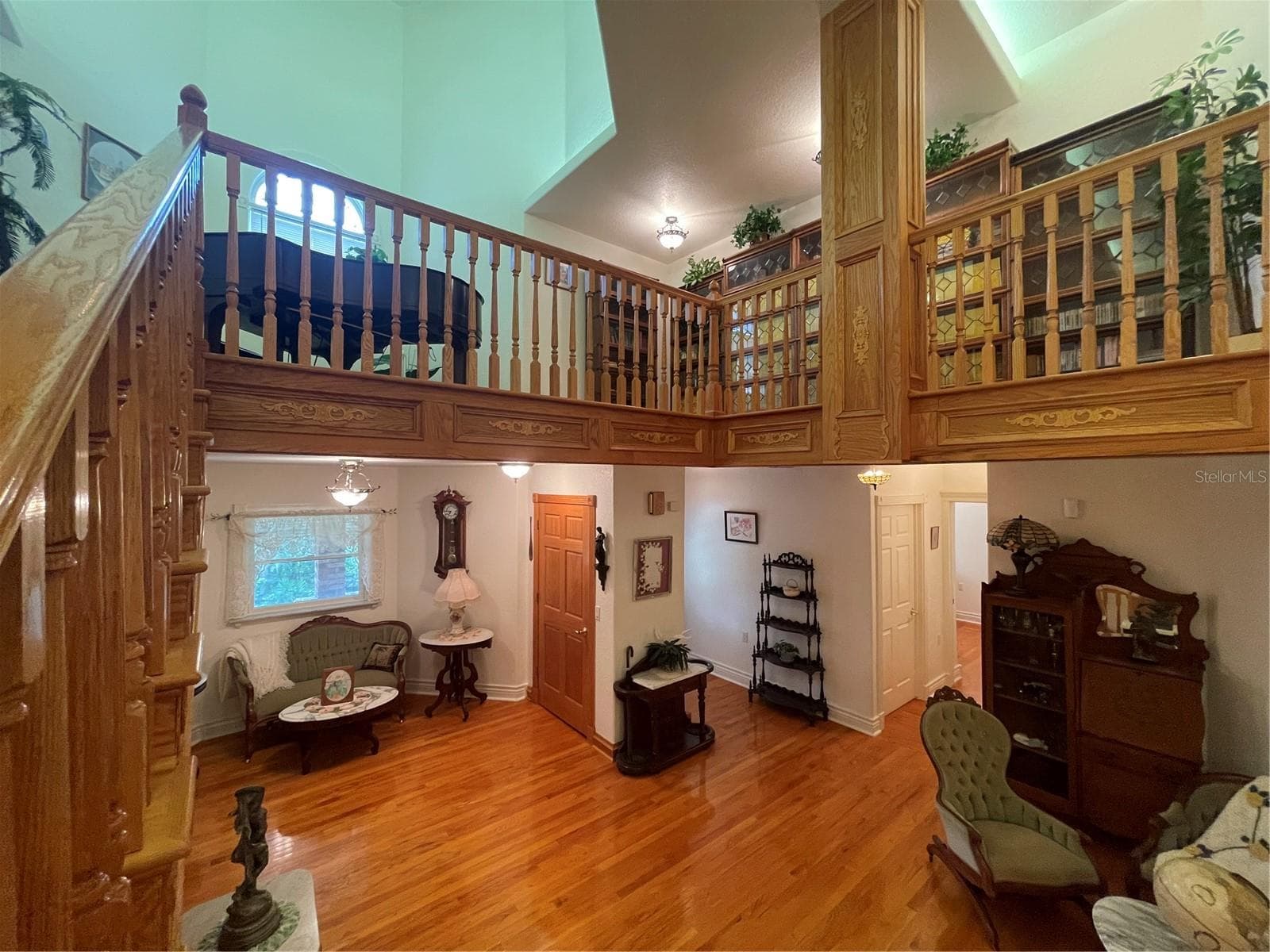 Marveling at the view of the second floor and the mezzanine on the 3rd floor - 5422 CYRIL DR, DADE CITY