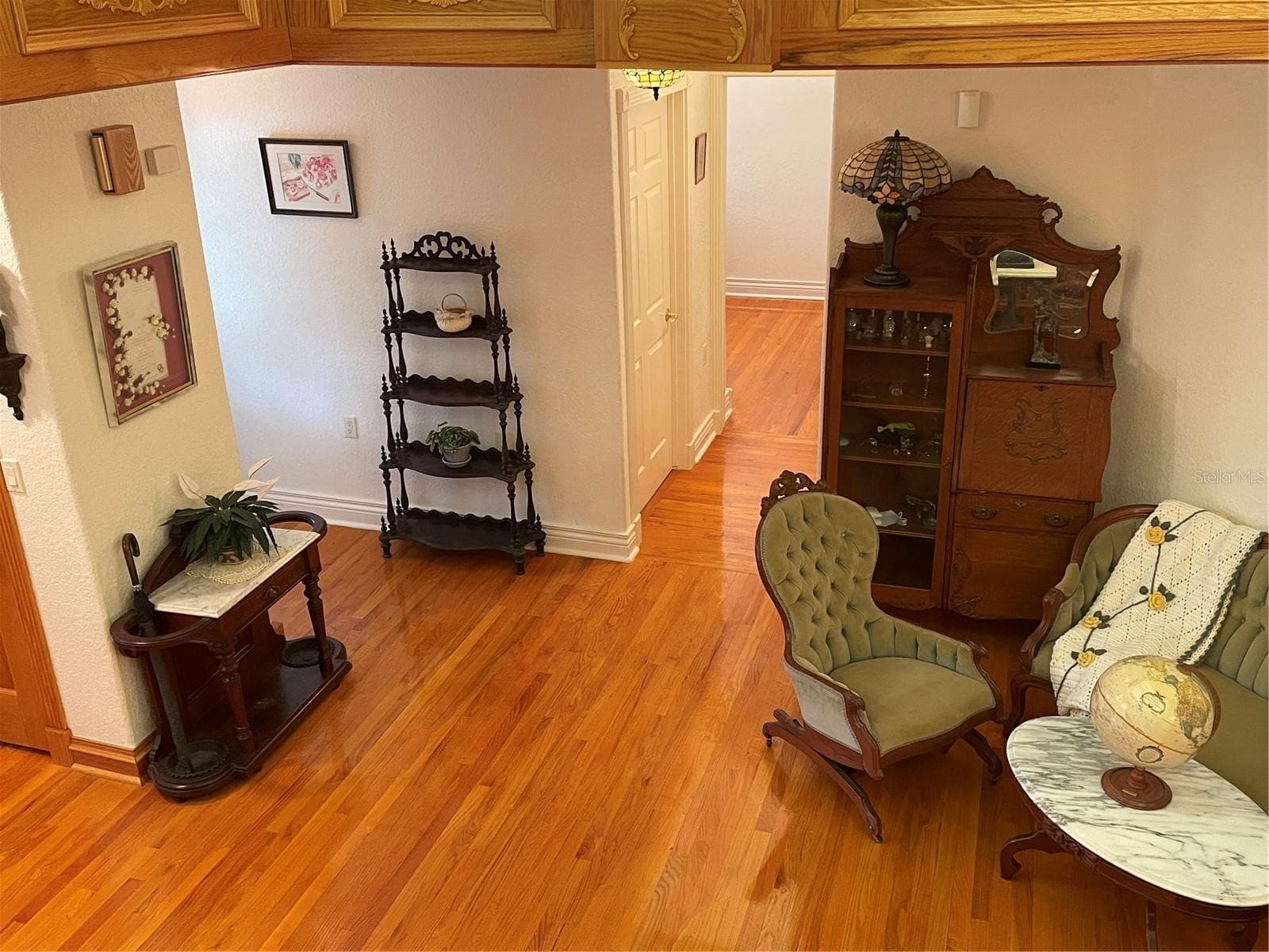 Ahead to the left is an exit door that leads to the balcony overlooking the front lawn. - 5422 CYRIL DR, DADE CITY