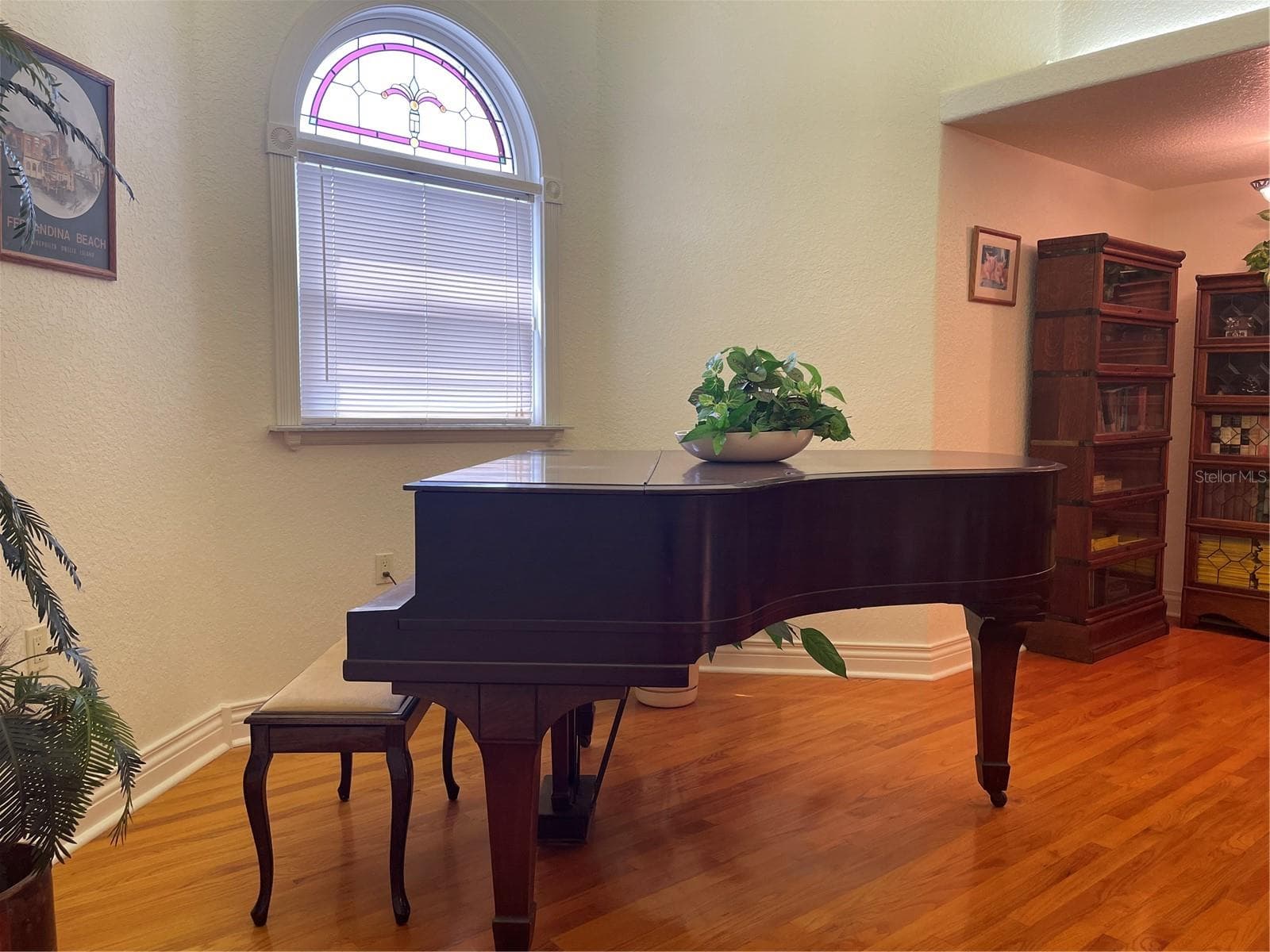 The grand piano is being gifted to the new home owner - 5422 CYRIL DR, DADE CITY