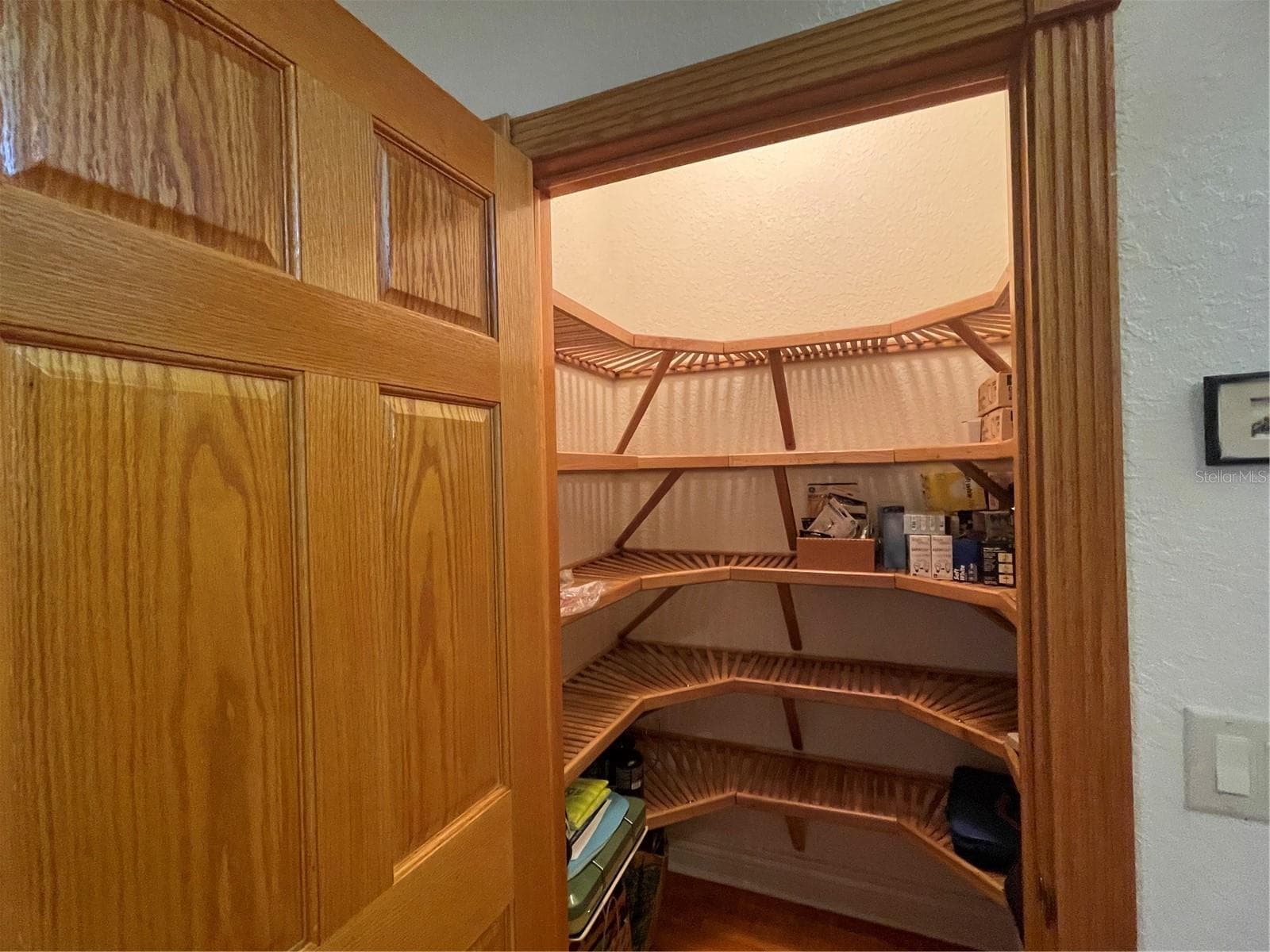 Walk in closet in 2nd bedroom has wood shelving. - 5422 CYRIL DR, DADE CITY