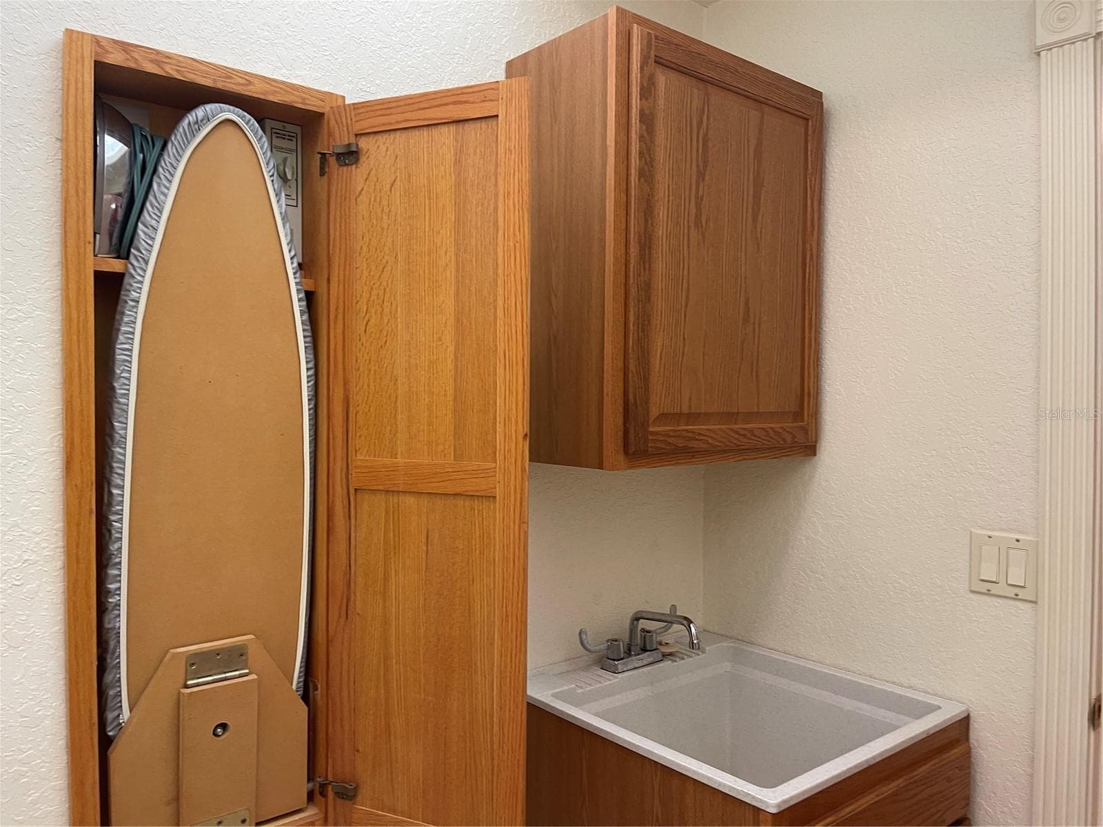 Wall cabinet for fold out ironing board, iron and built in light. - 5422 CYRIL DR, DADE CITY
