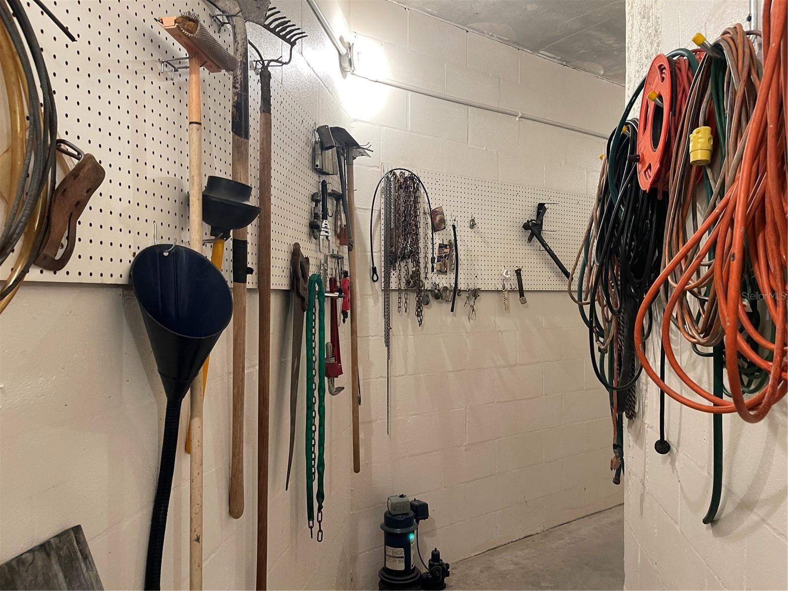 Plenty of hooks and peg board for hanging tools and equipment - 5422 CYRIL DR, DADE CITY