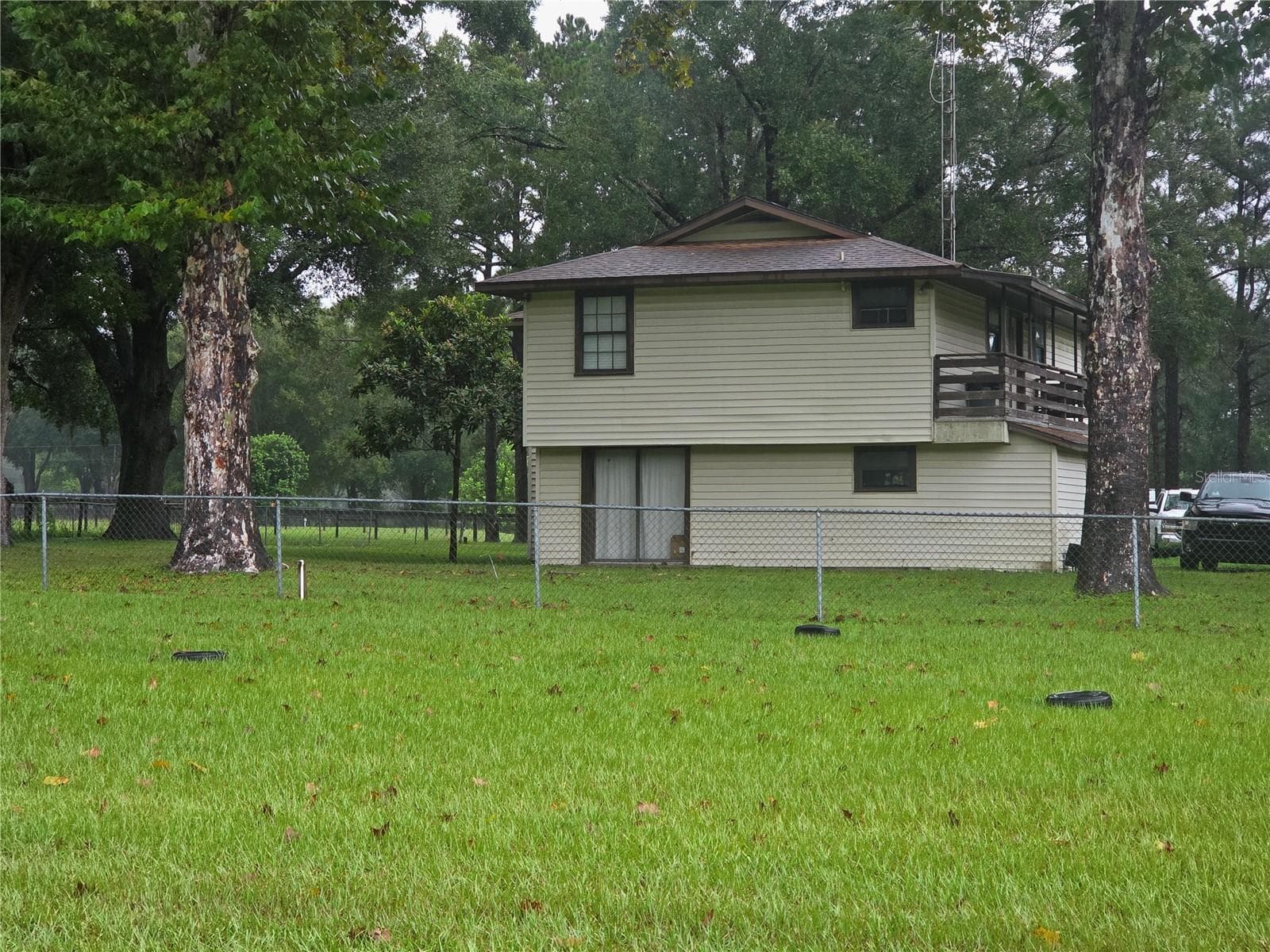 2 story house with deck on North and South sides on a Rainy day - 950 W HIGHWAY 316, CITRA