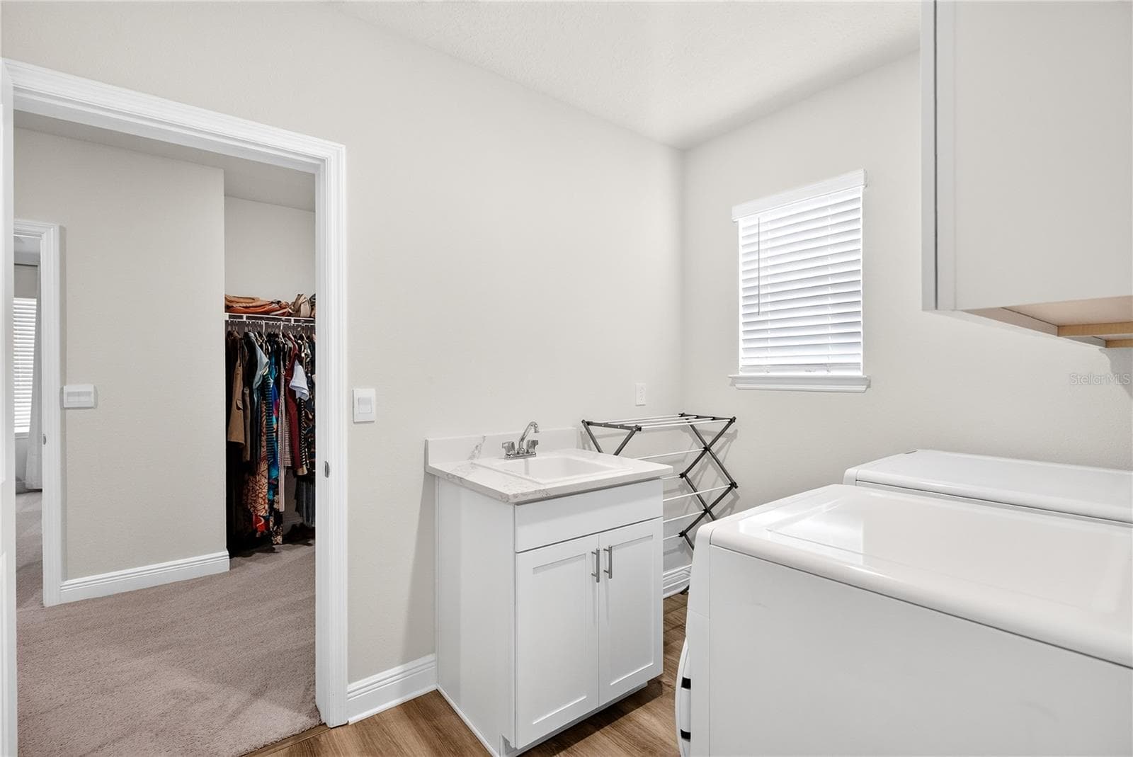 Laundry room off primary bed closet - 18009 TAVERNSIDE TRL, LAKEWOOD RANCH