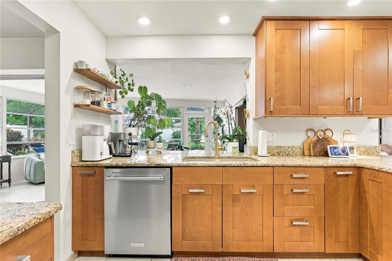 Kitchen overlooking sun room to back patio and pool - 10211 139TH ST, LARGO