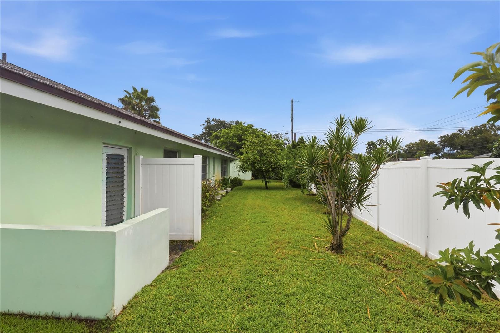 side yard with fruit trees and garage access door - 10211 139TH ST, LARGO